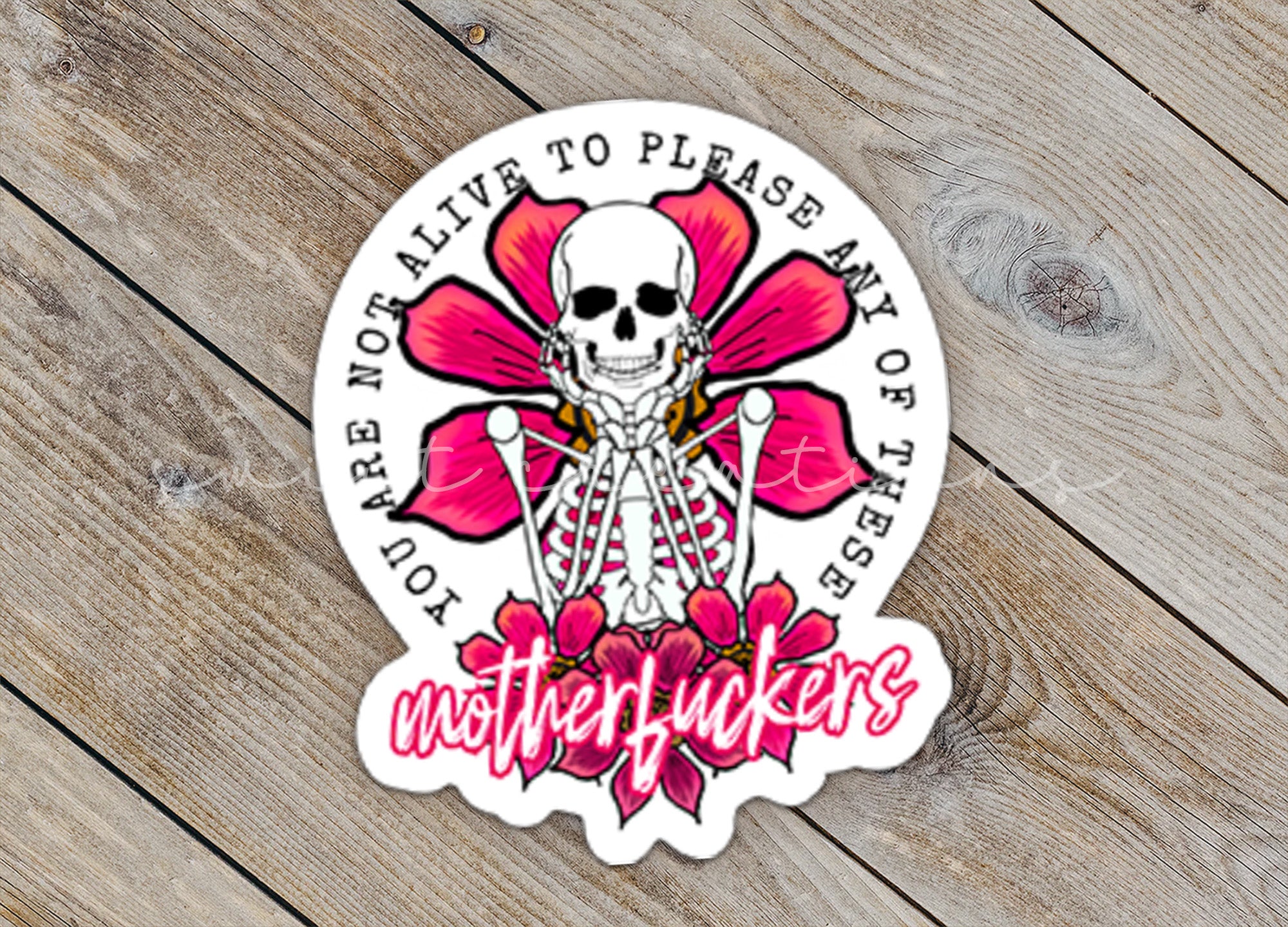 a sticker with a skull and flowers on it
