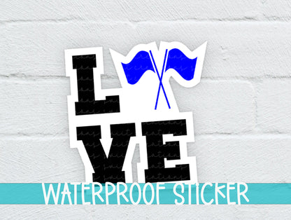 a white brick wall with a blue and black sticker on it