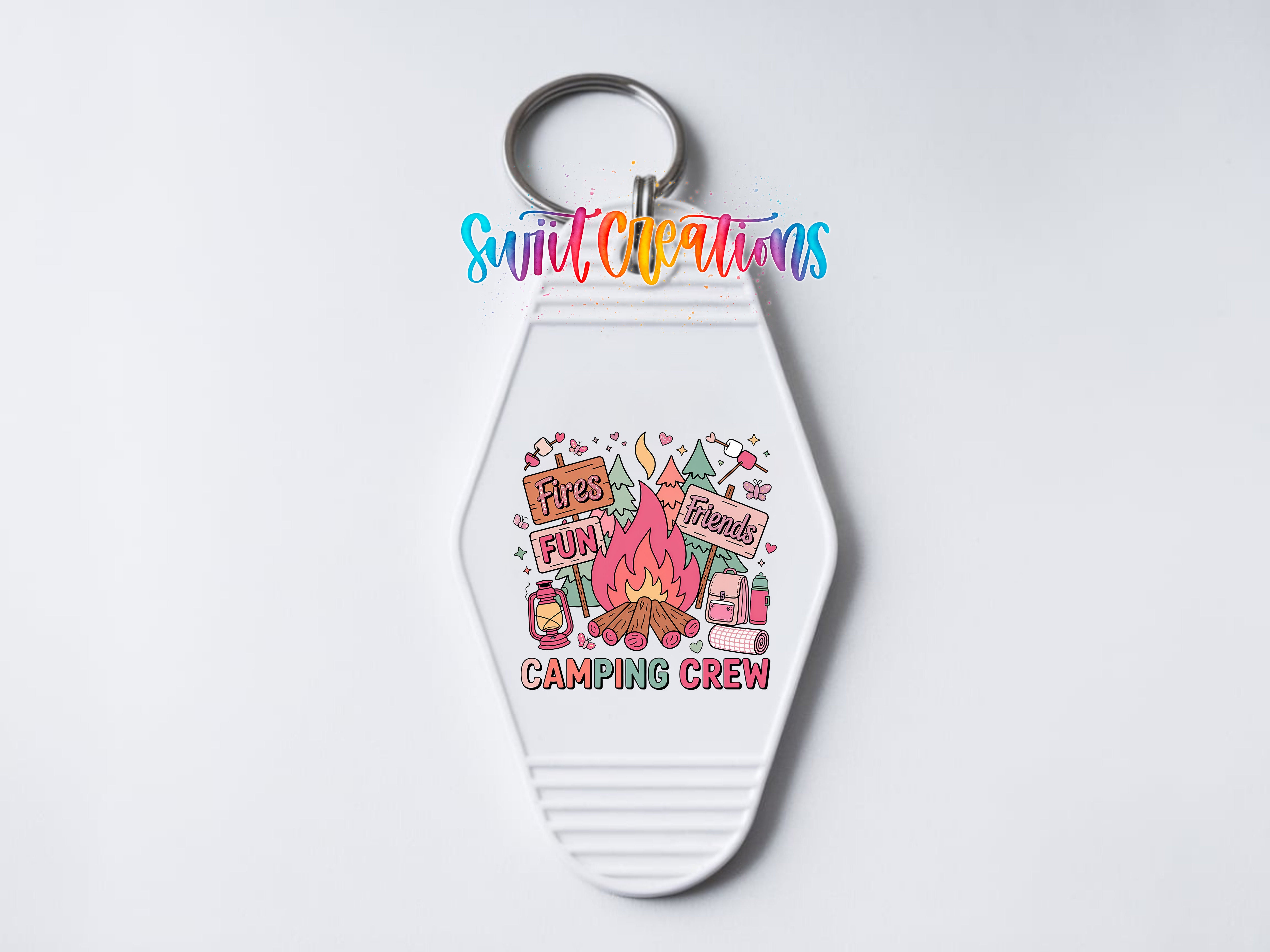 A keychain with a colorful design featuring camping-related items and text.