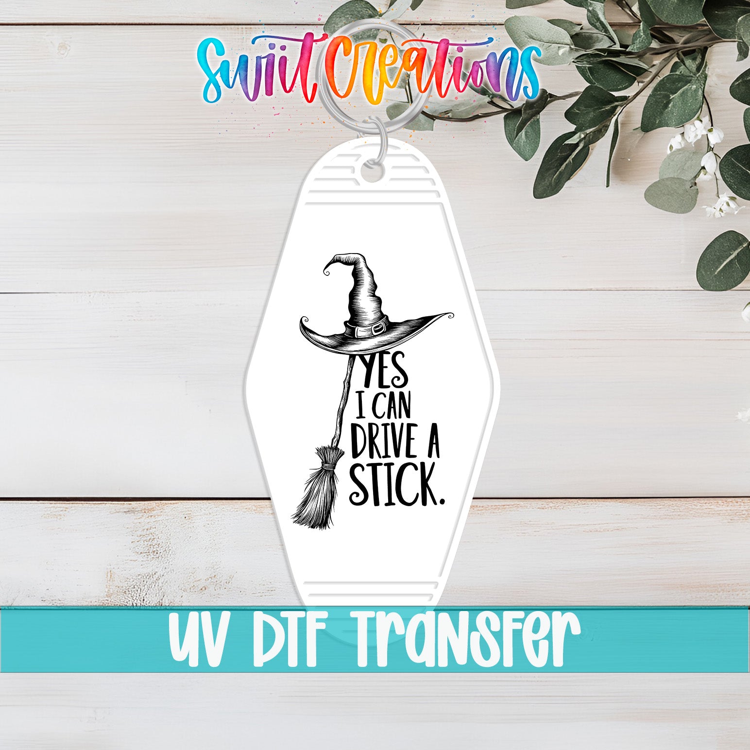 A keychain with a witch's hat and the text "YES I CAN DRIVE A STICK" printed on it.