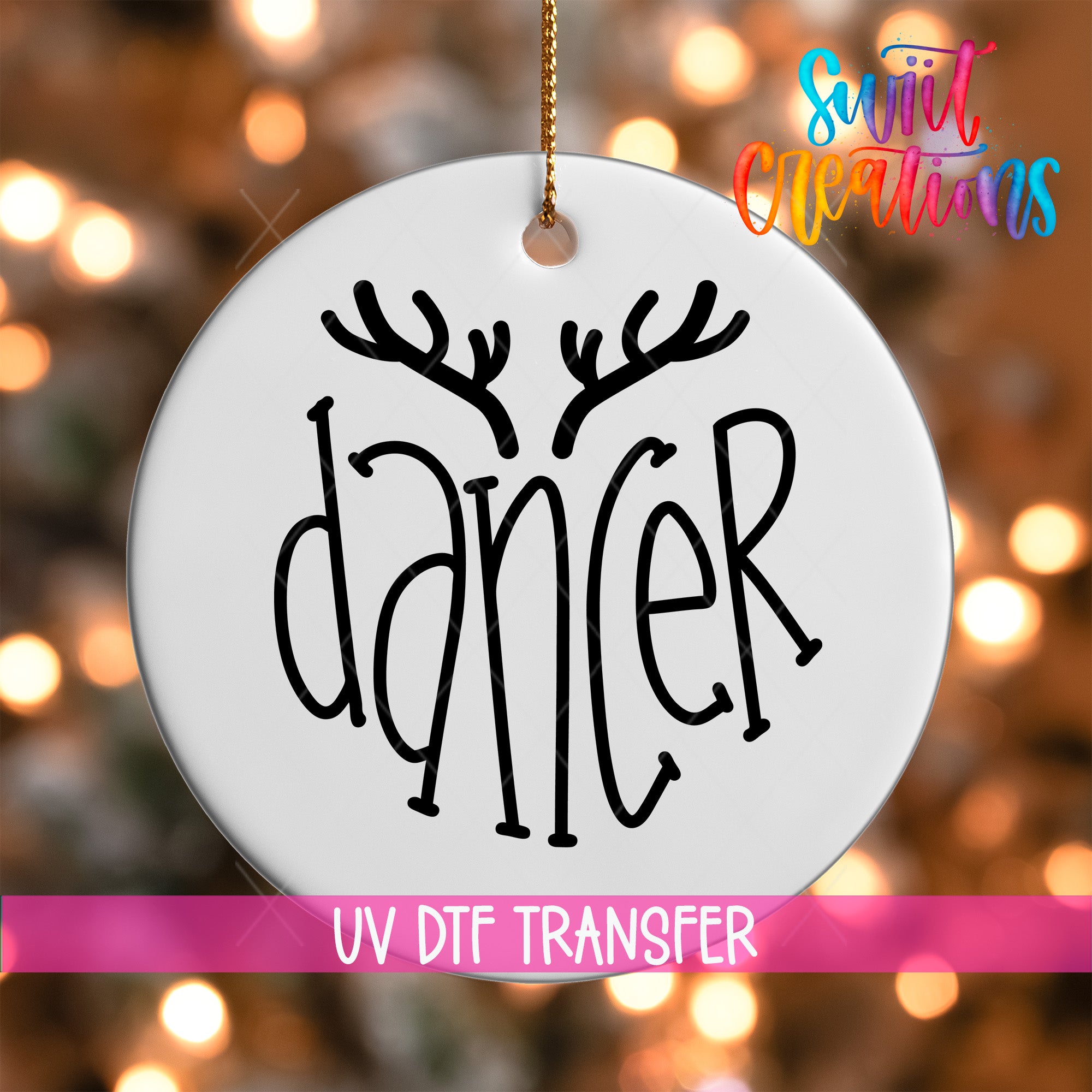 A white ornament with the word "dancer" written on it, hanging against a background of colorful lights.