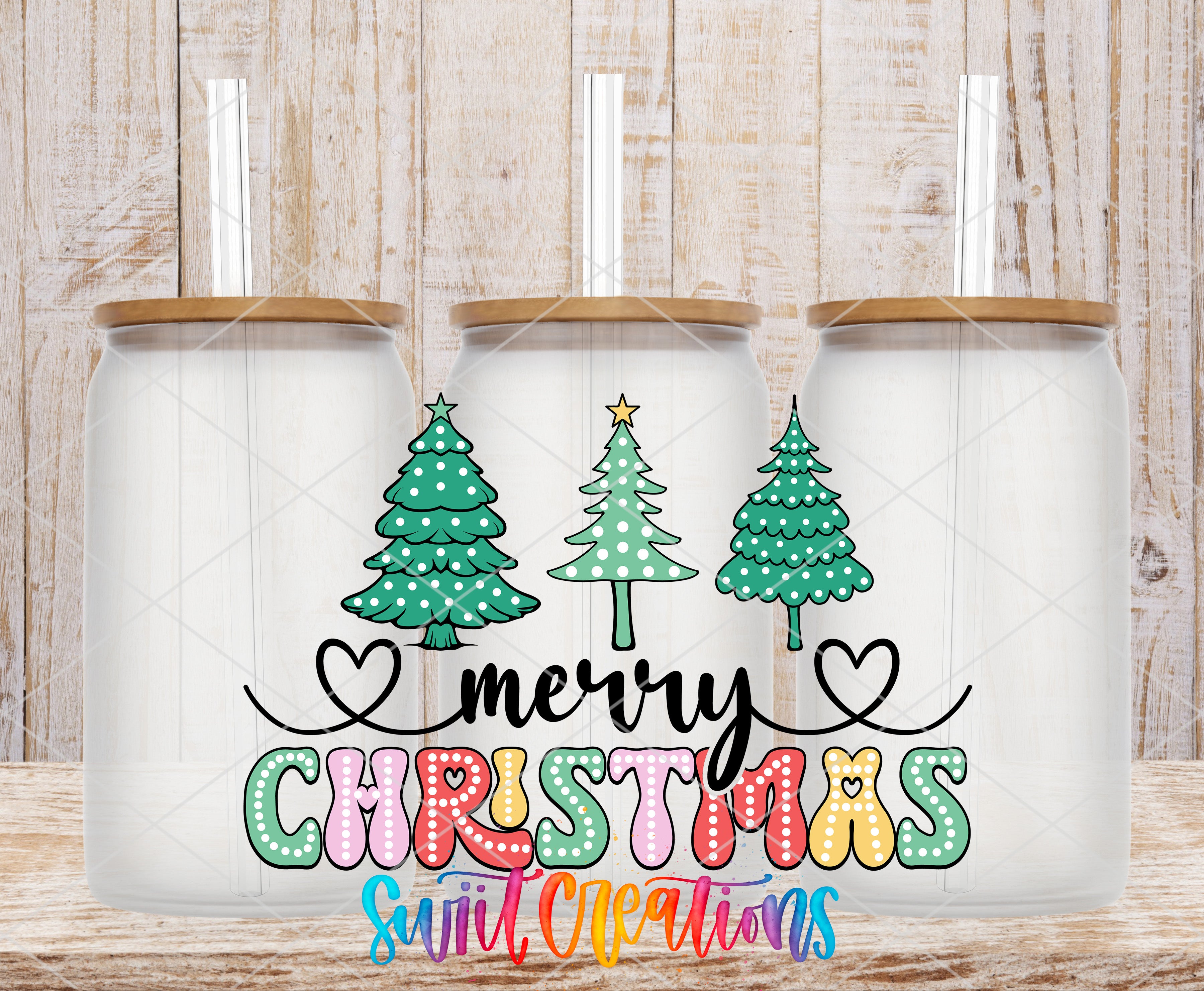 three glass jars with Christmas tree designs and a "Merry Christmas" message written on them.
