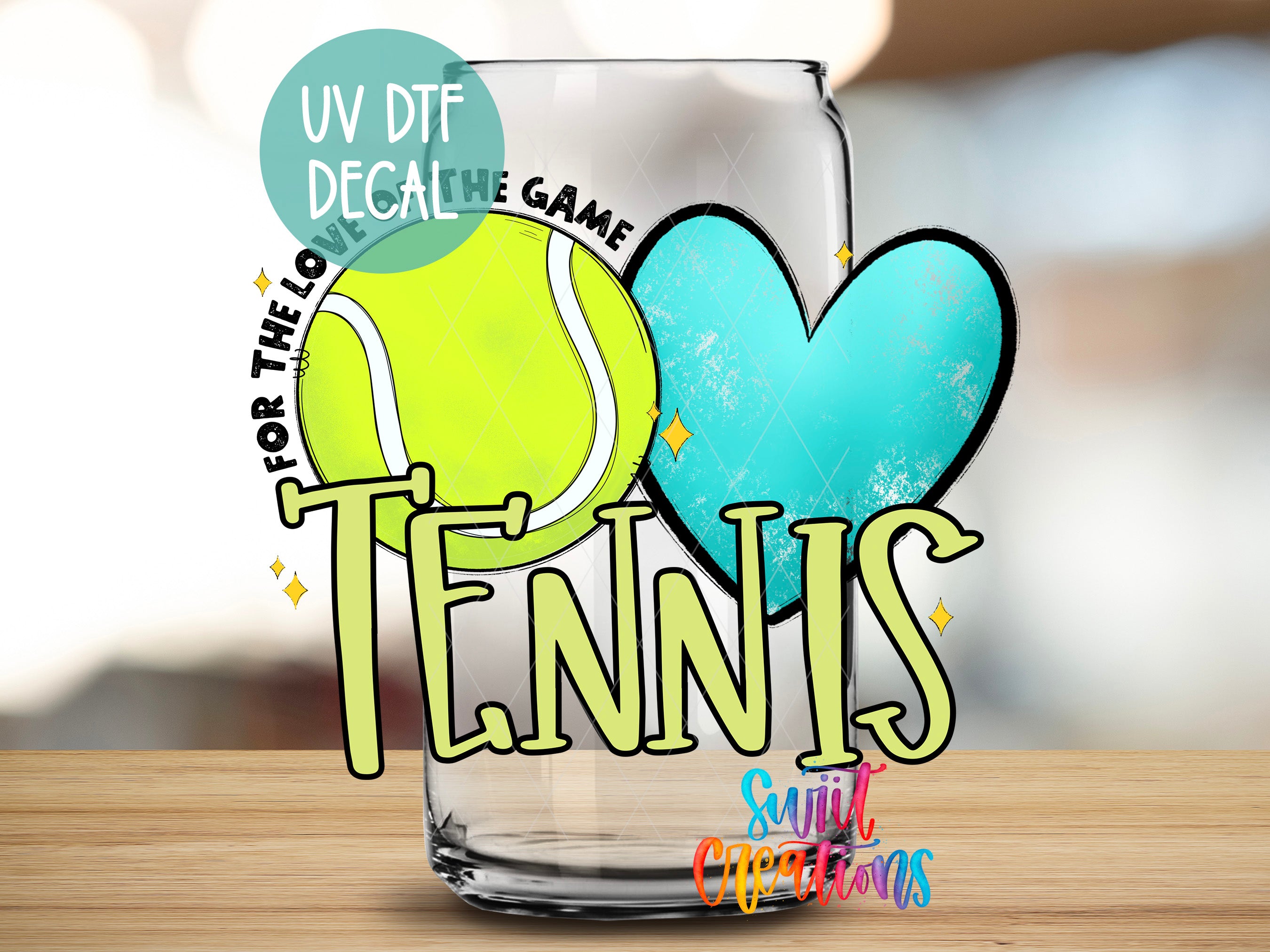 A glass with a tennis ball and a heart on it, along with the text "TENNIS" and "UV DFT DECAL" written on it.