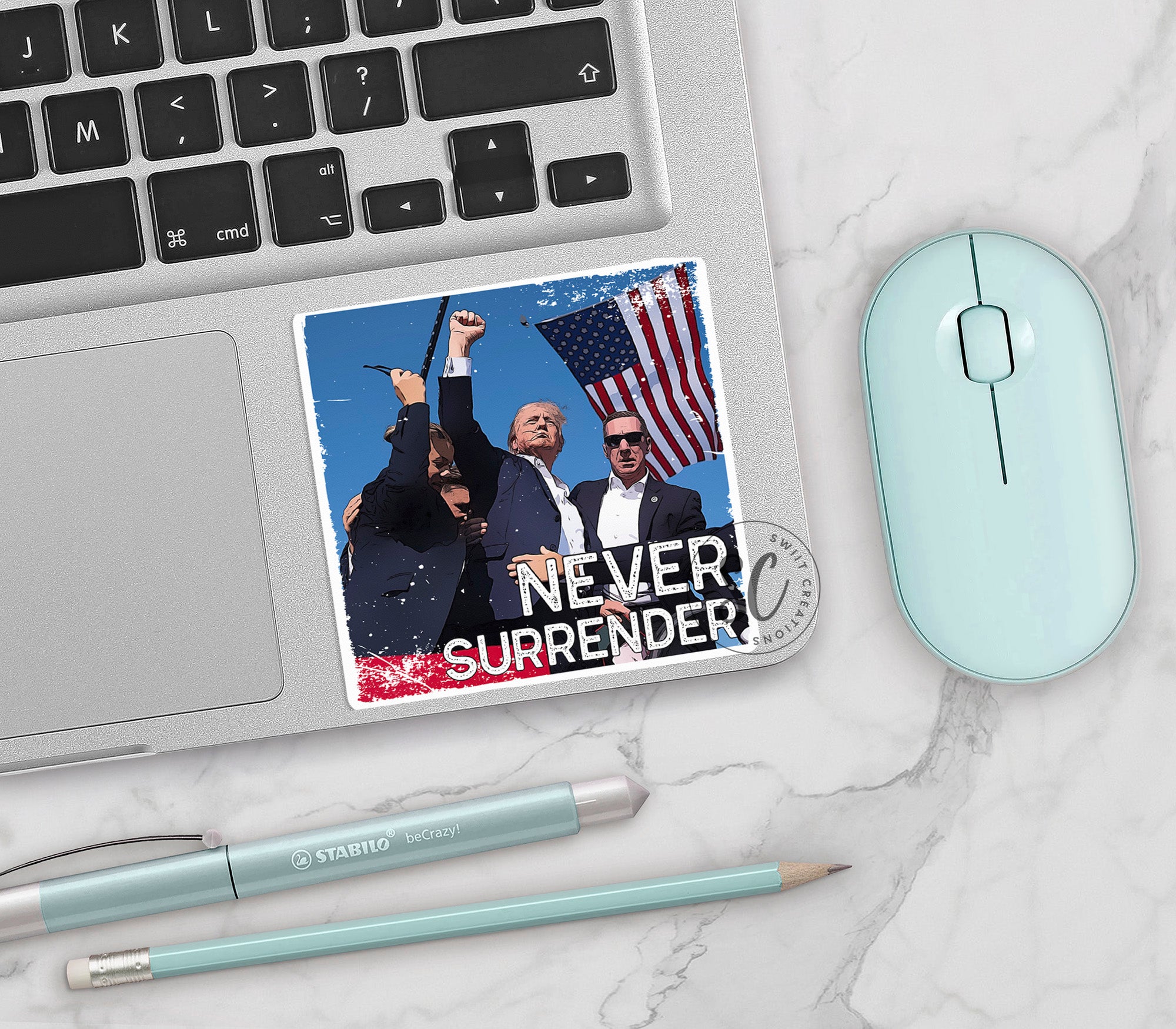 a laptop with a sticker of two men and a flag on it