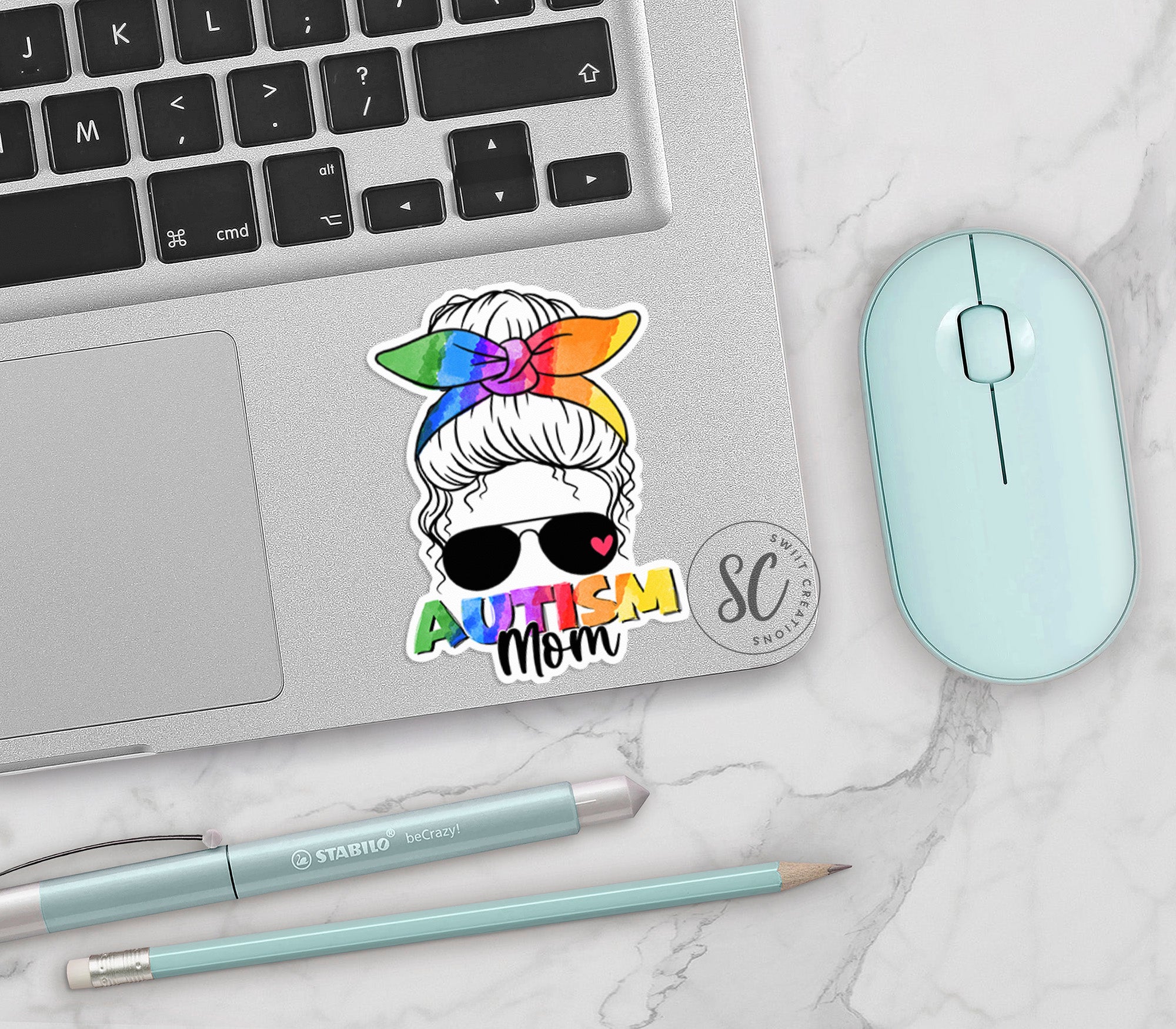 a laptop with a sticker of a woman with a rainbow bow on her head