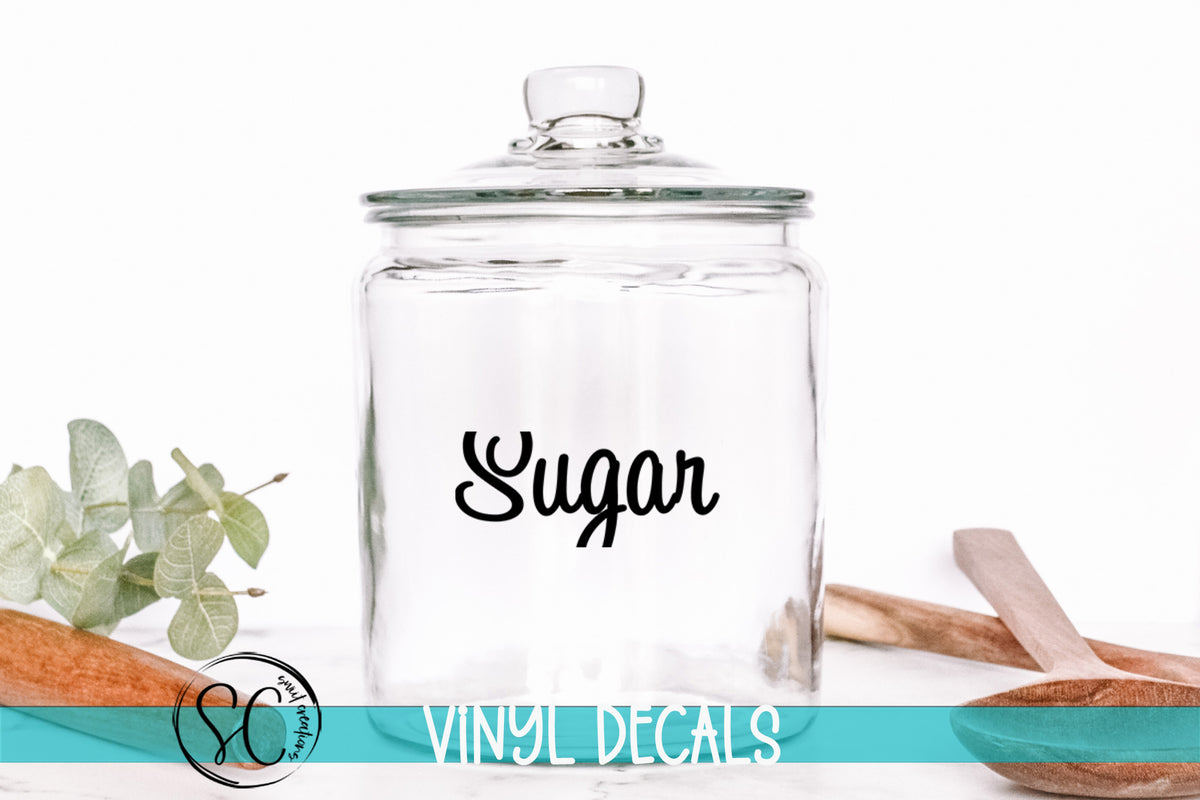 a glass jar with the word sugar on it