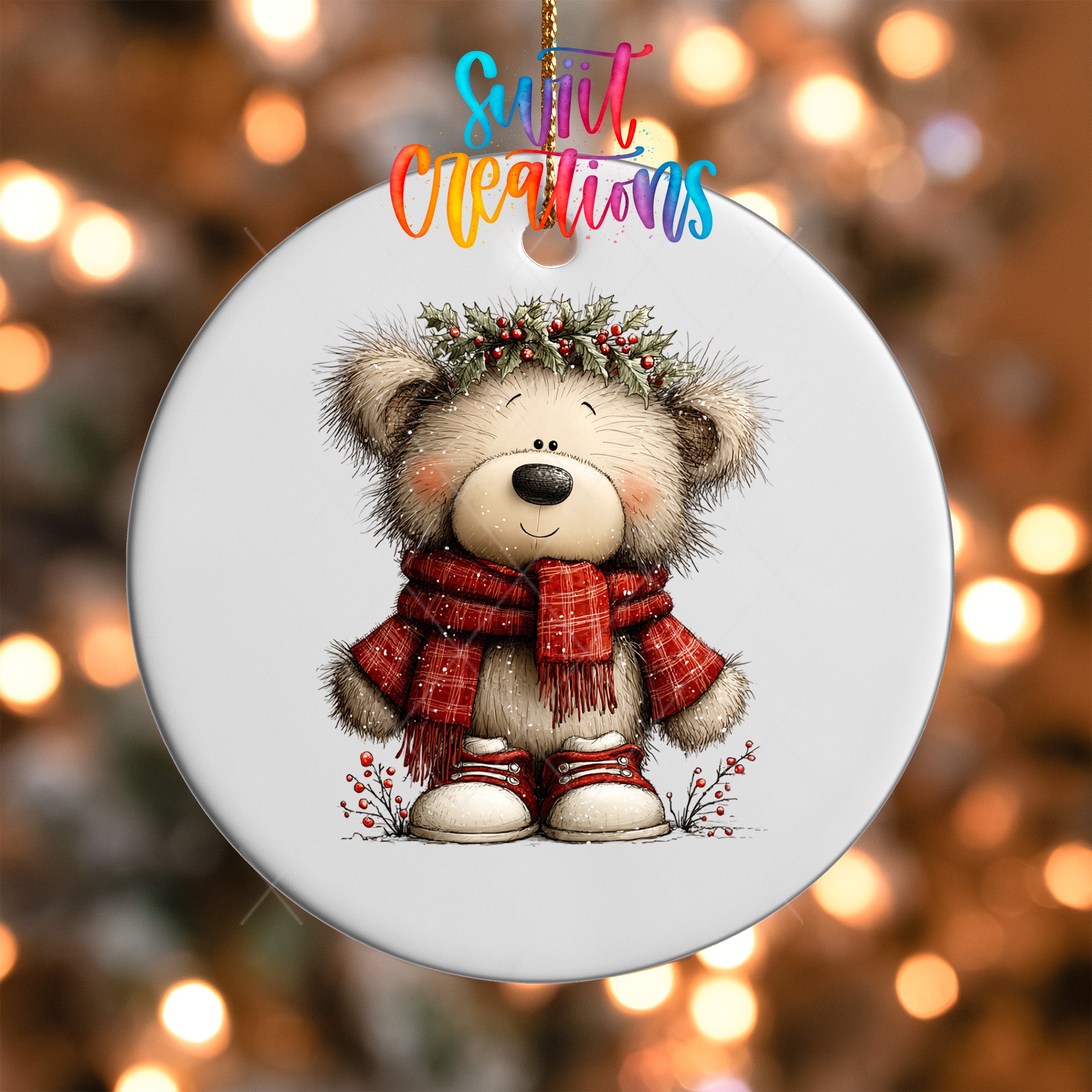 A white ceramic ornament featuring a cute teddy bear wearing a red scarf and a holly wreath on its head, set against a blurred background with colorful lights.