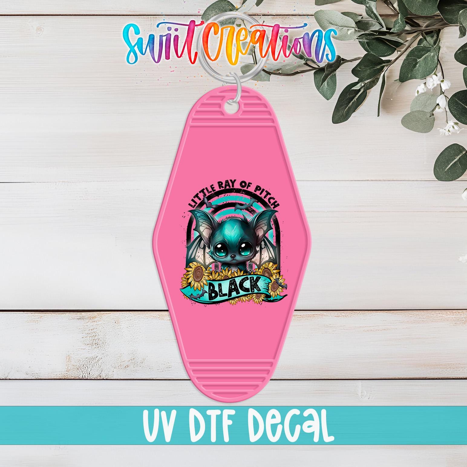 A pink keychain with a cartoon image of a cat and the text "Little Ray of Pitch" and "Black" printed on it, along with the text "UV Dtf Decal".