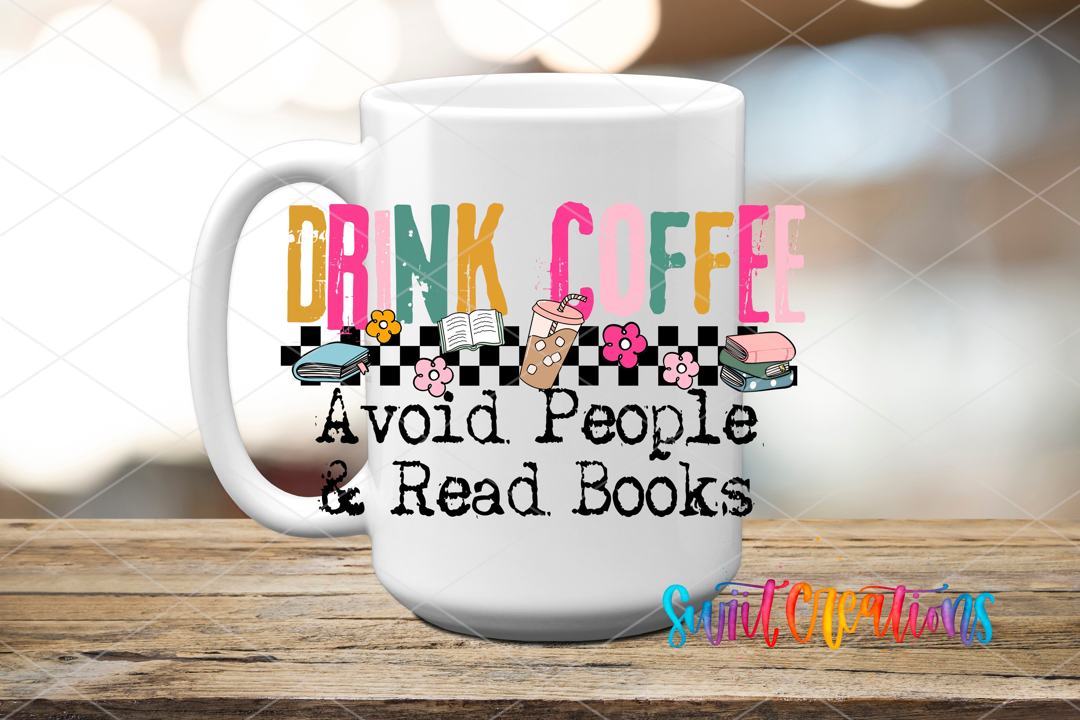 A white mug with colorful text and illustrations on it, placed on a wooden surface.
