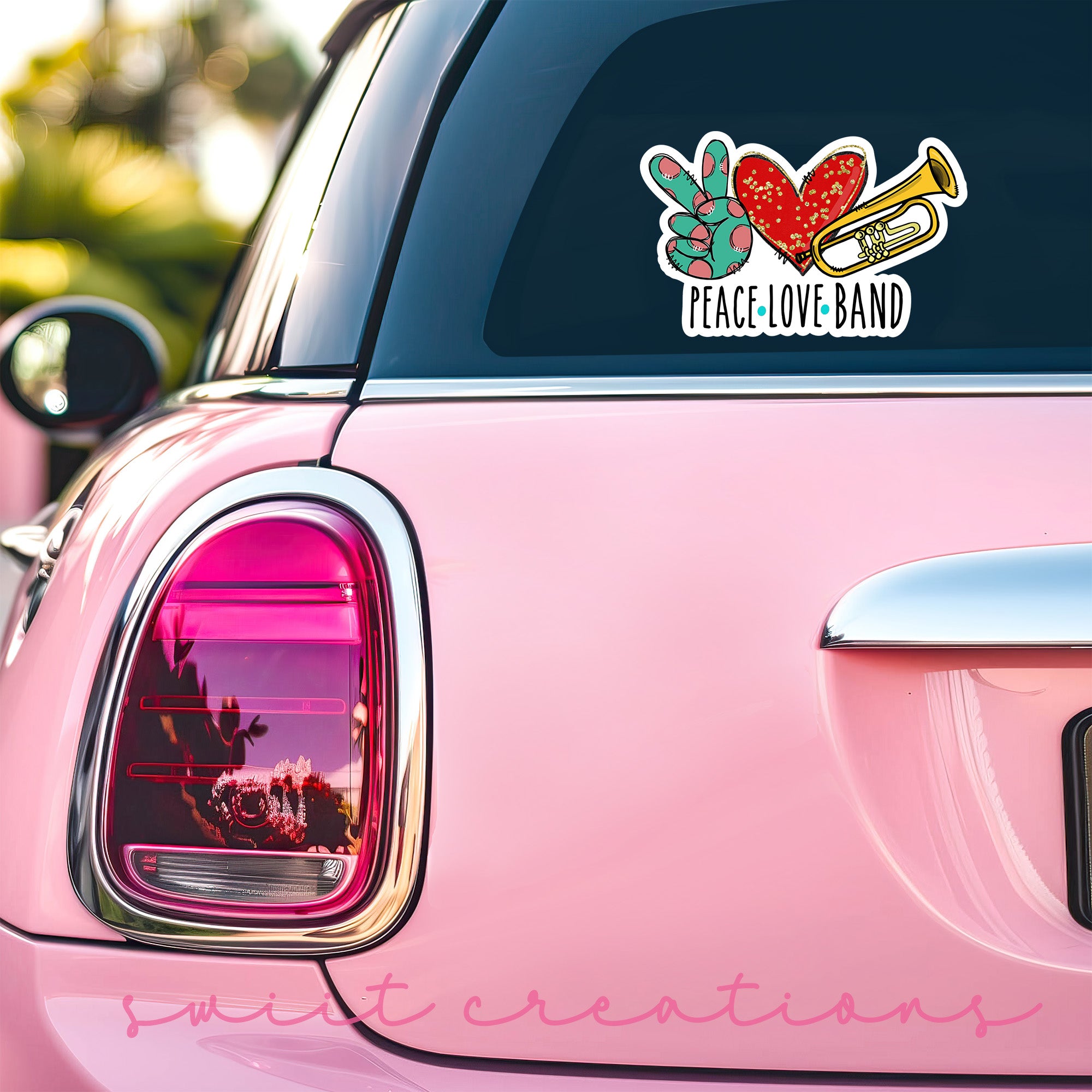 a pink car with a peace love band sticker on it