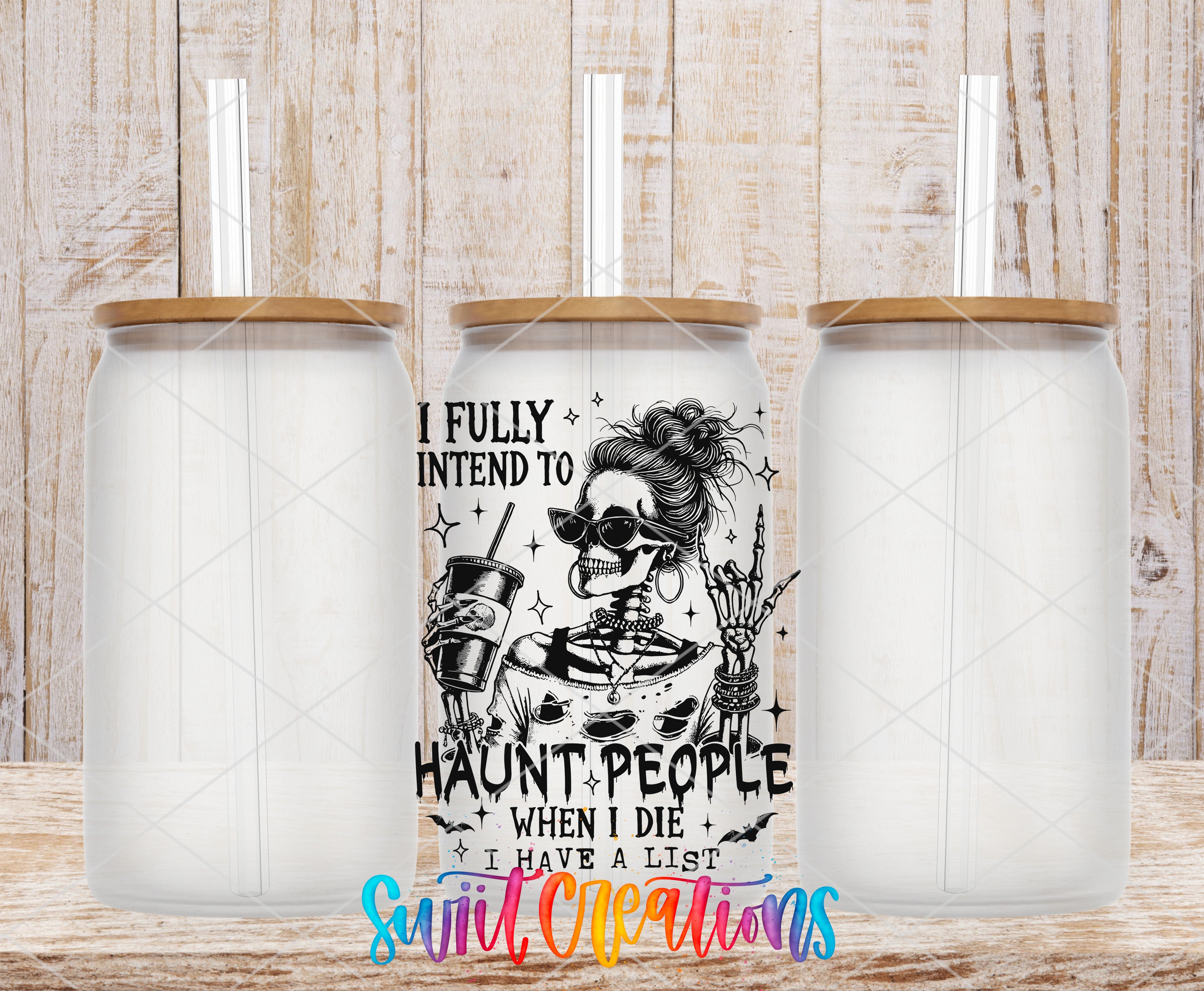 a clear glass jar with a lid and straw, along with a printed design on the jar depicting a skeleton with a skull and crossbones.