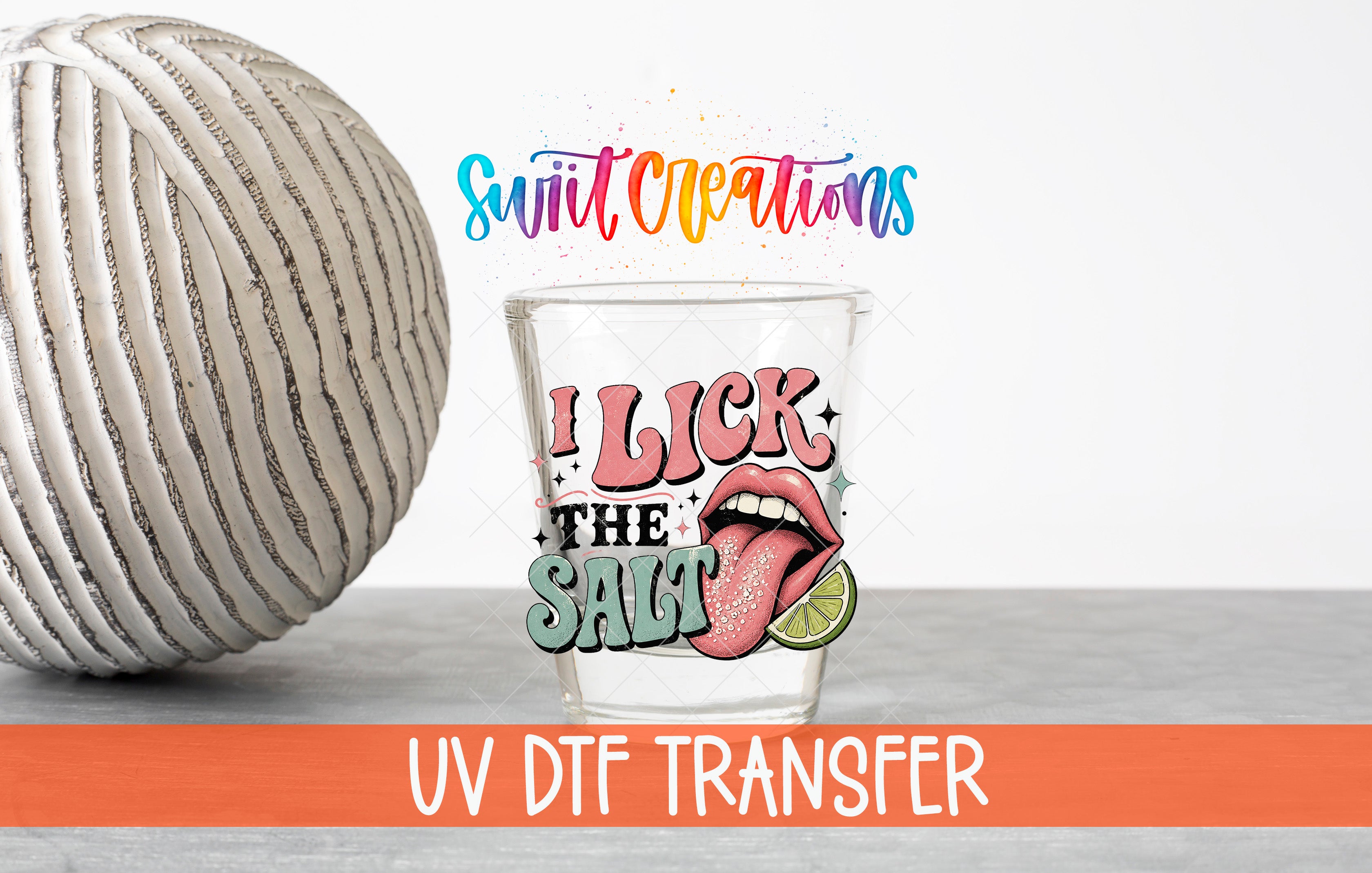 a glass with a colorful design and text, along with a large white ball and a text overlay that says "Swit Creations UV Dtf Transfer".