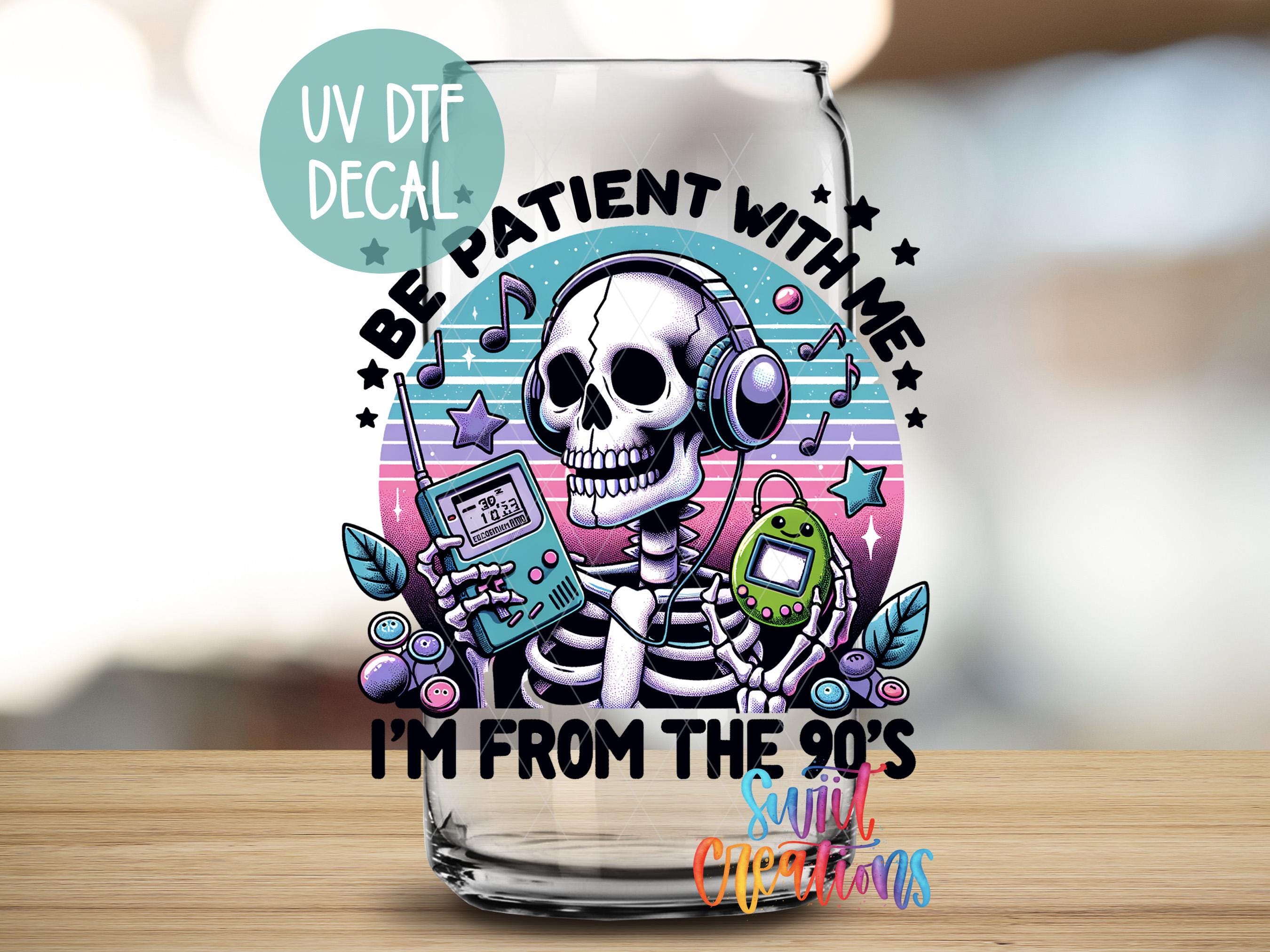 a glass with a skeleton holding a cell phone