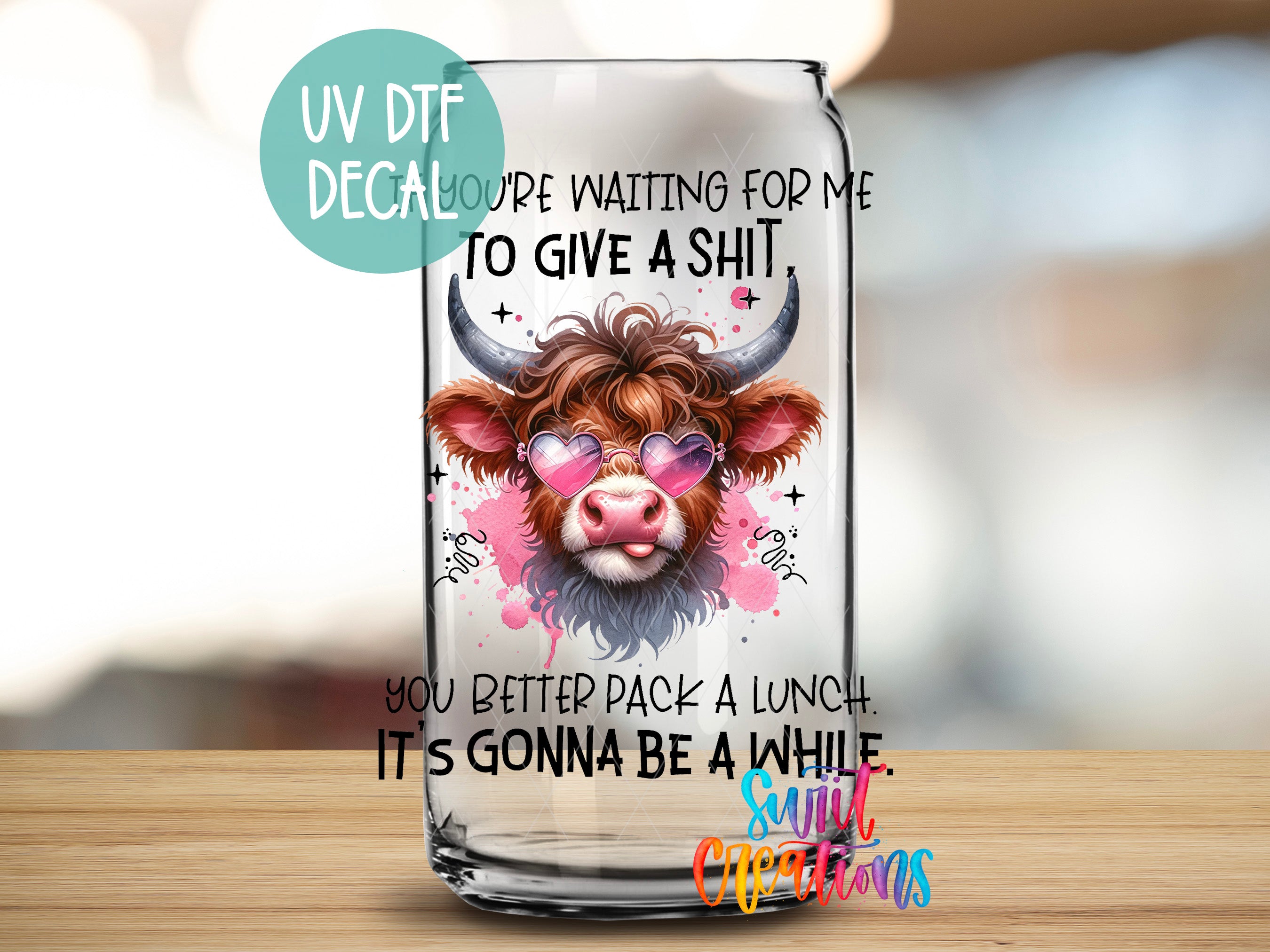 a glass with a picture of a cow wearing sunglasses