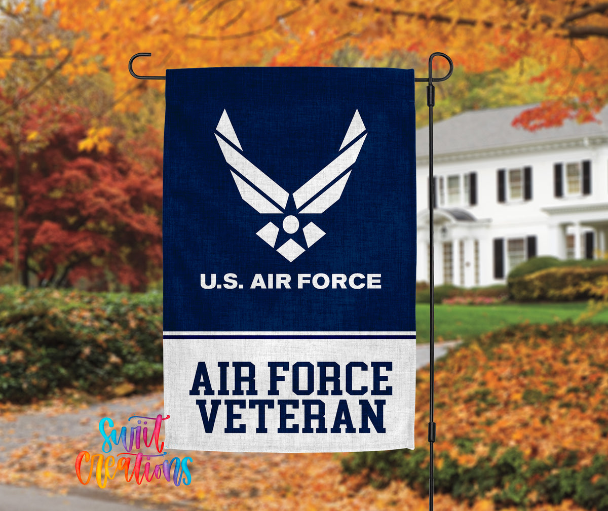 A flag with the U.S. Air Force logo and the text "AIR FORCE VETERAN" is displayed in front of a house with autumn foliage in the background.