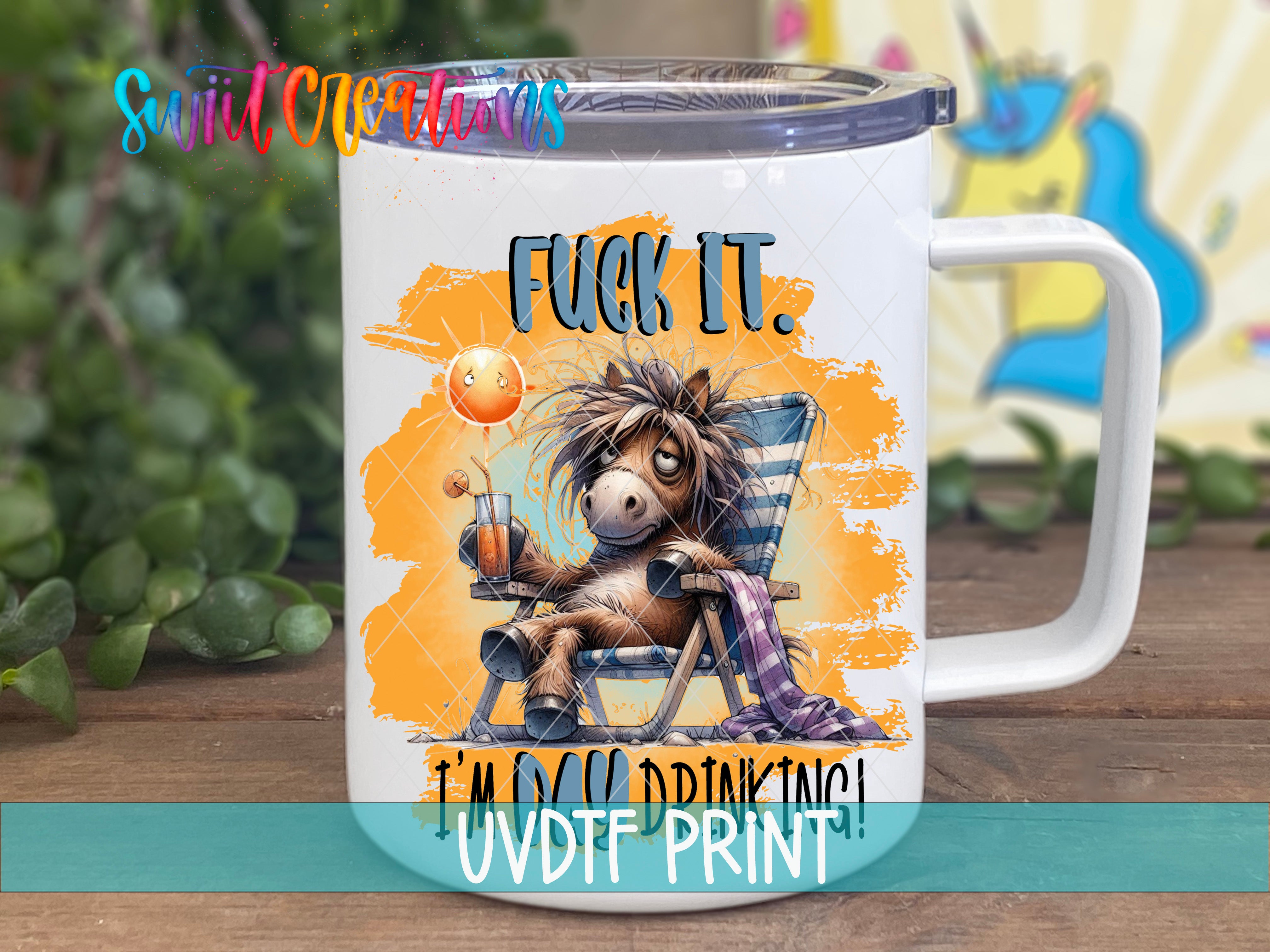 A mug with a cartoon image of a horse sitting in a chair, holding a drink, and the text "FUCK IT" and "I'm drinking!" printed on it.