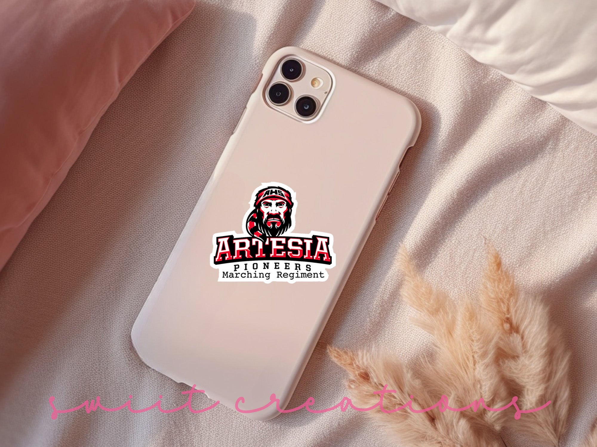 a phone case sitting on top of a bed