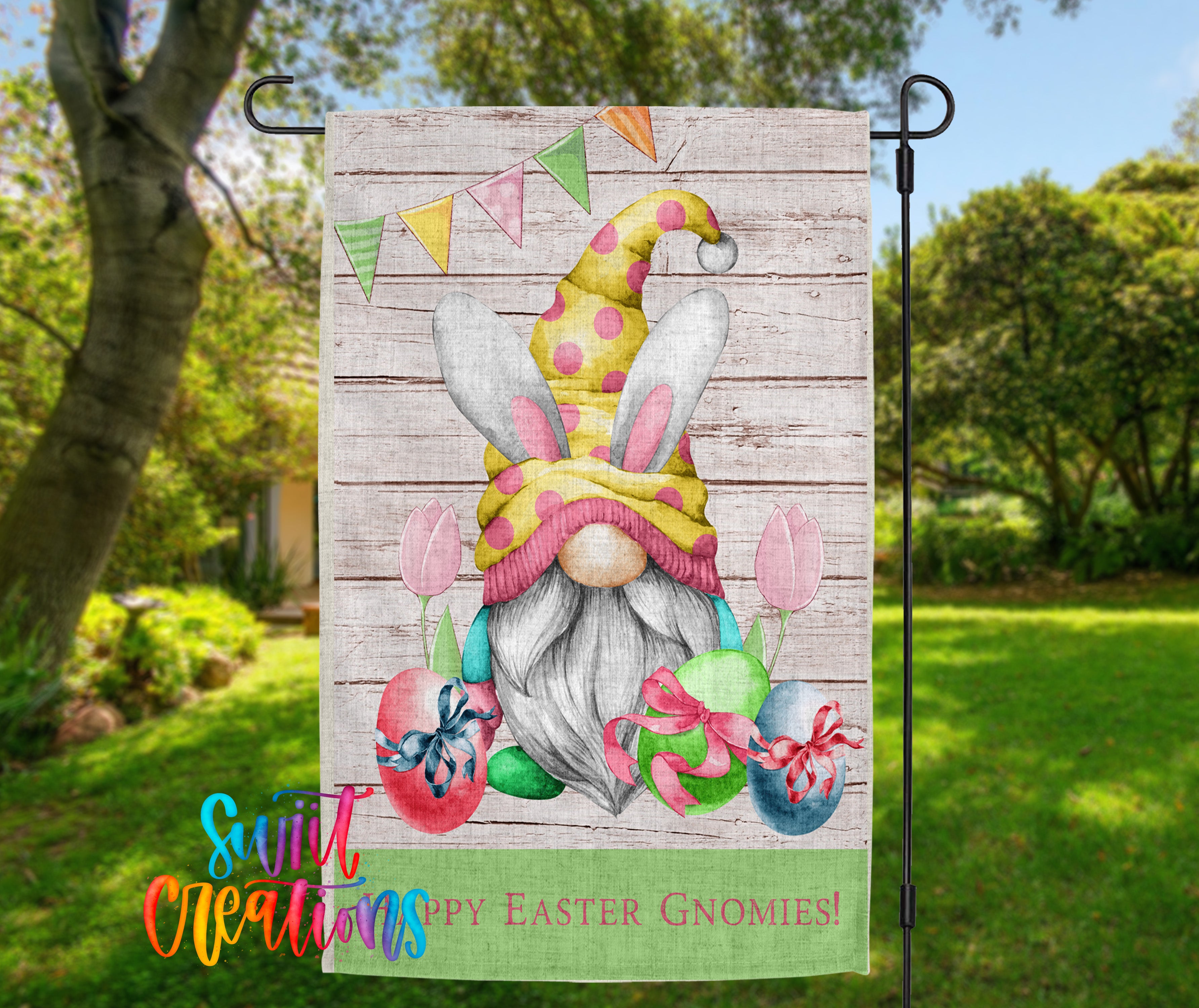 A colorful garden gnome sign with Easter decorations, including eggs, flowers, and a banner with the text "Happy Easter gnomes!"