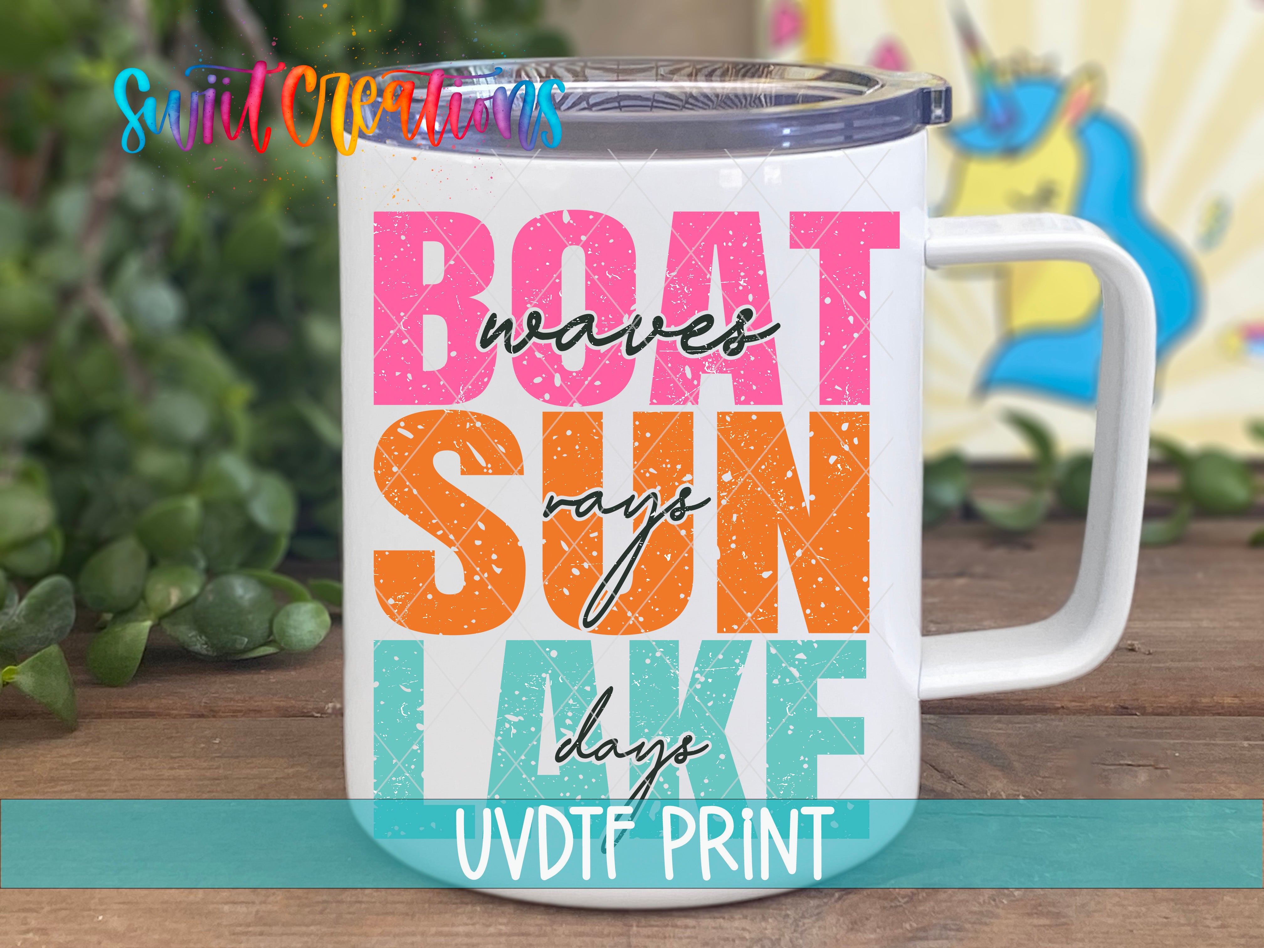 A white mug with colorful text that says "BOAT SUN LAKE" printed on it.