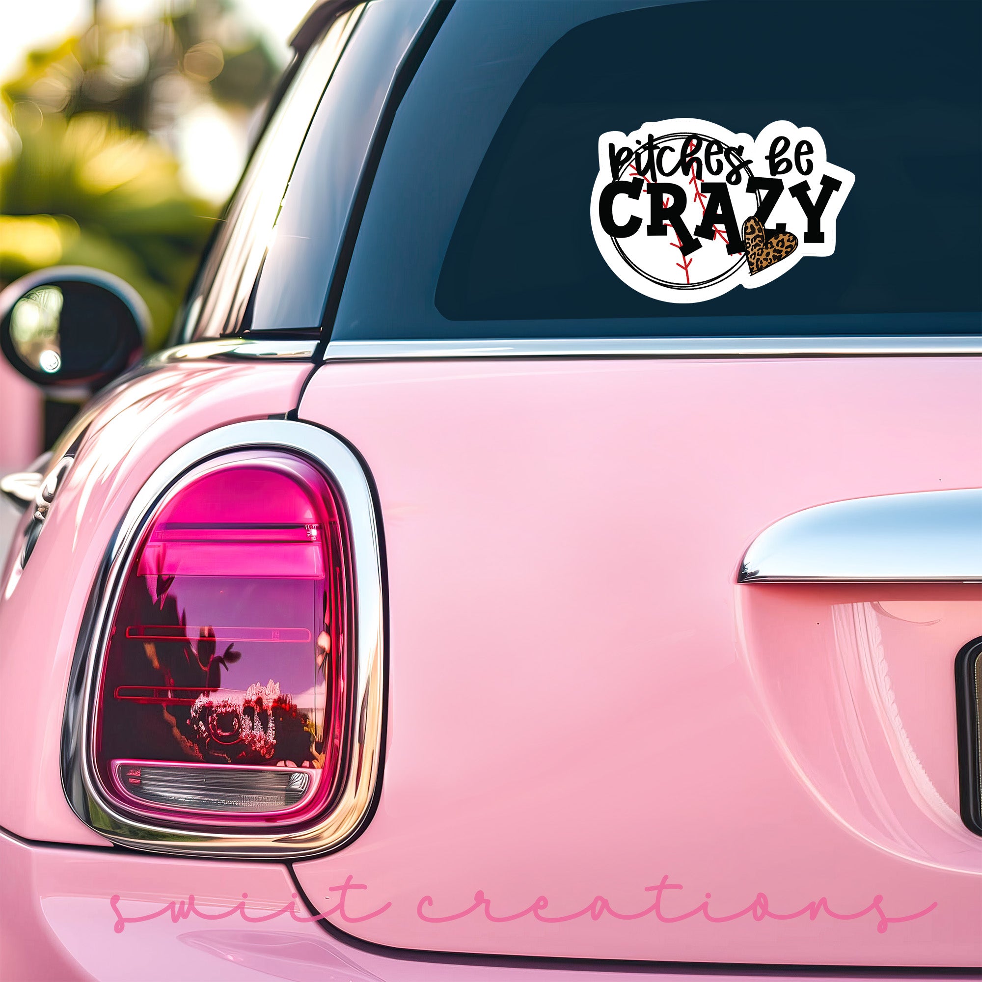 a pink car that has a sticker on it
