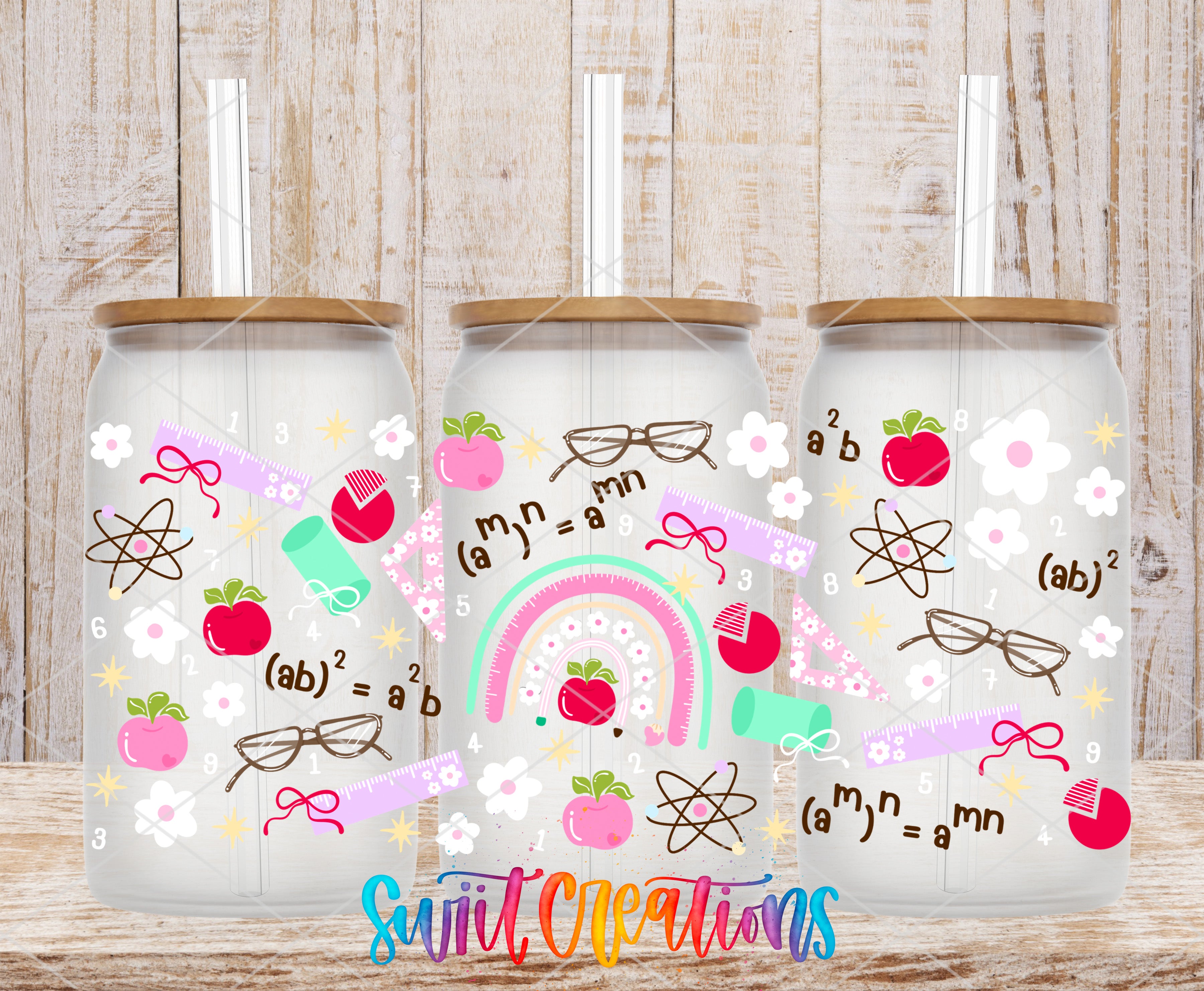 three glass tumblers with various colorful and whimsical designs, including apples, glasses, and scientific symbols such as a rainbow and a periodic table.