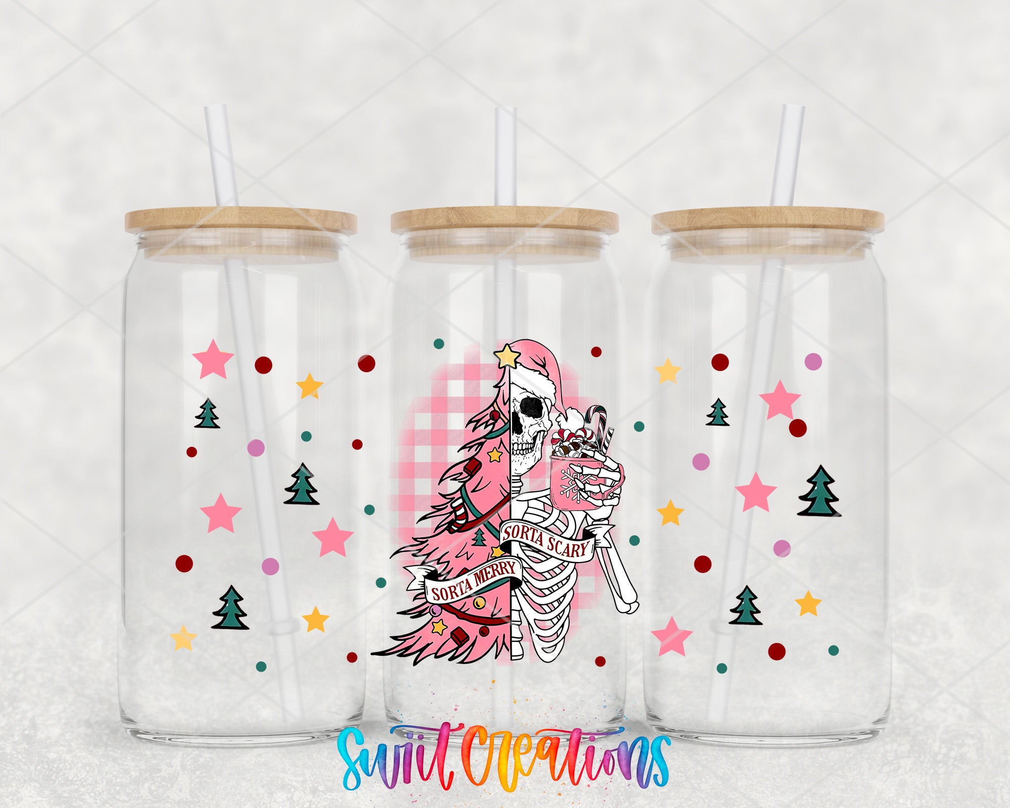three clear glass tumblers with unique designs and decorations. The tumblers have a wooden lid and are decorated with Christmas-themed elements such as stars, pine trees, and a skeleton. The text "SORTIA SCARY" is visible on the tumbler, suggesting a humorous or eerie theme.