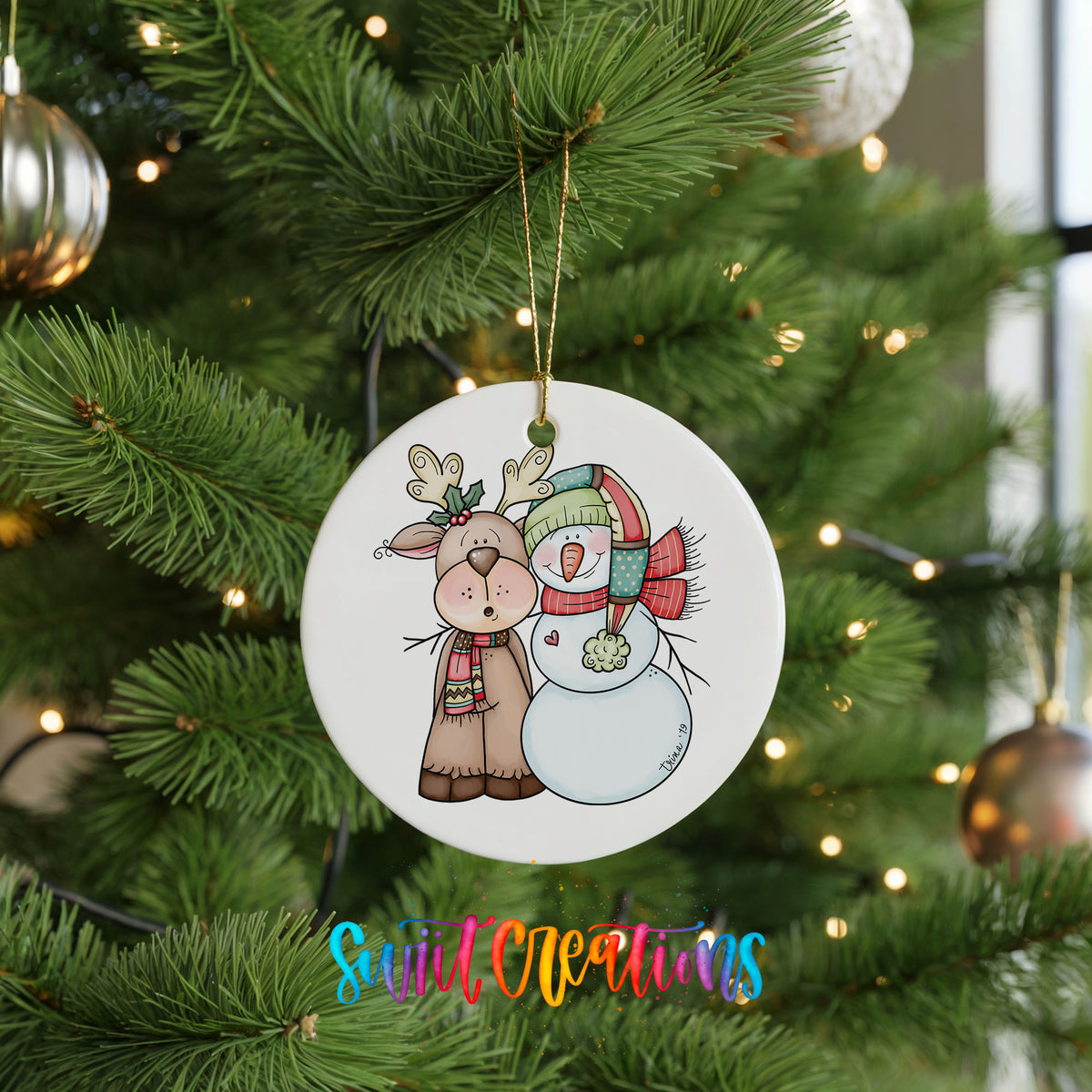 Cute reindeer and snowman ornament hanging on a green Christmas tree