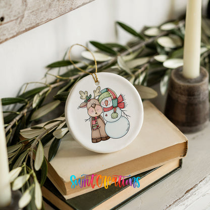 Reindeer and snowman ornament styled on books with holiday greenery