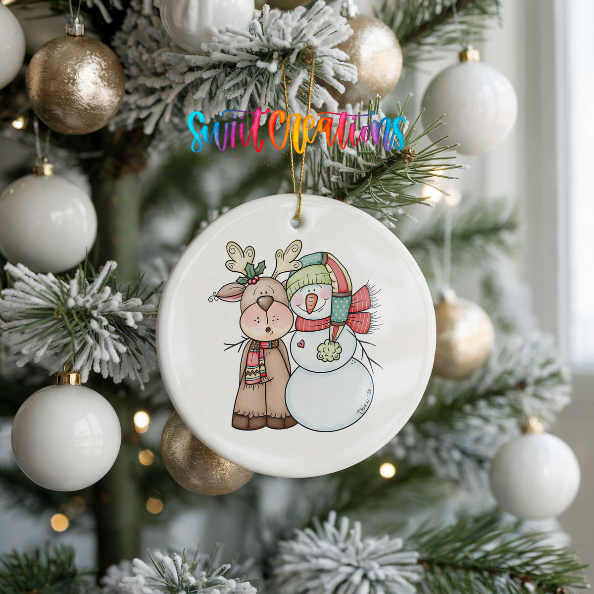 Reindeer and snowman ornament on a frosted Christmas tree
