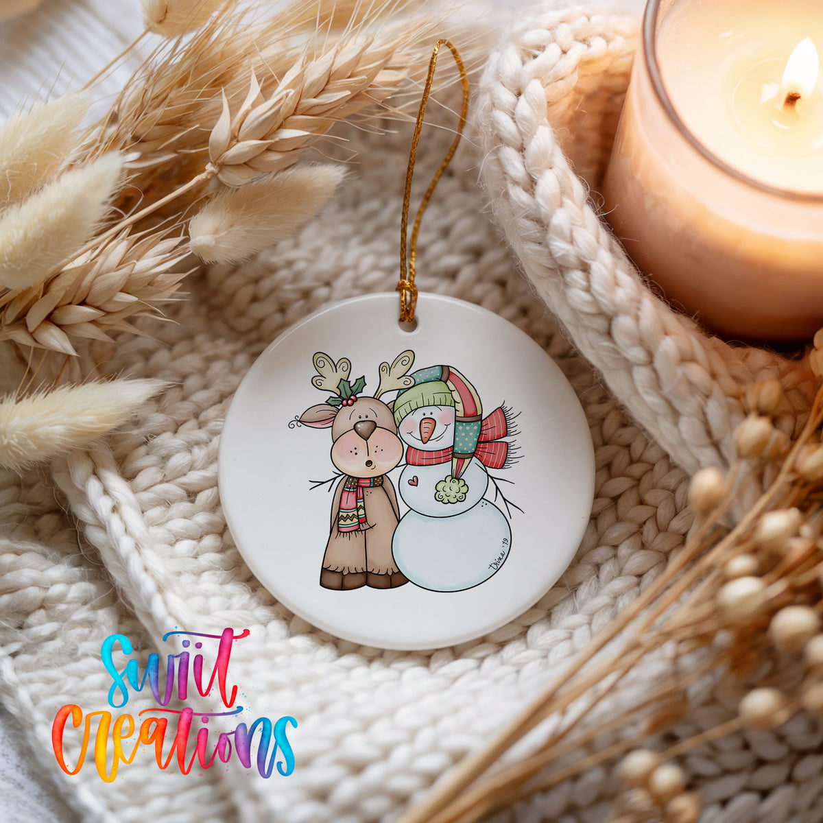 Reindeer and snowman holiday ornament styled beside a candle