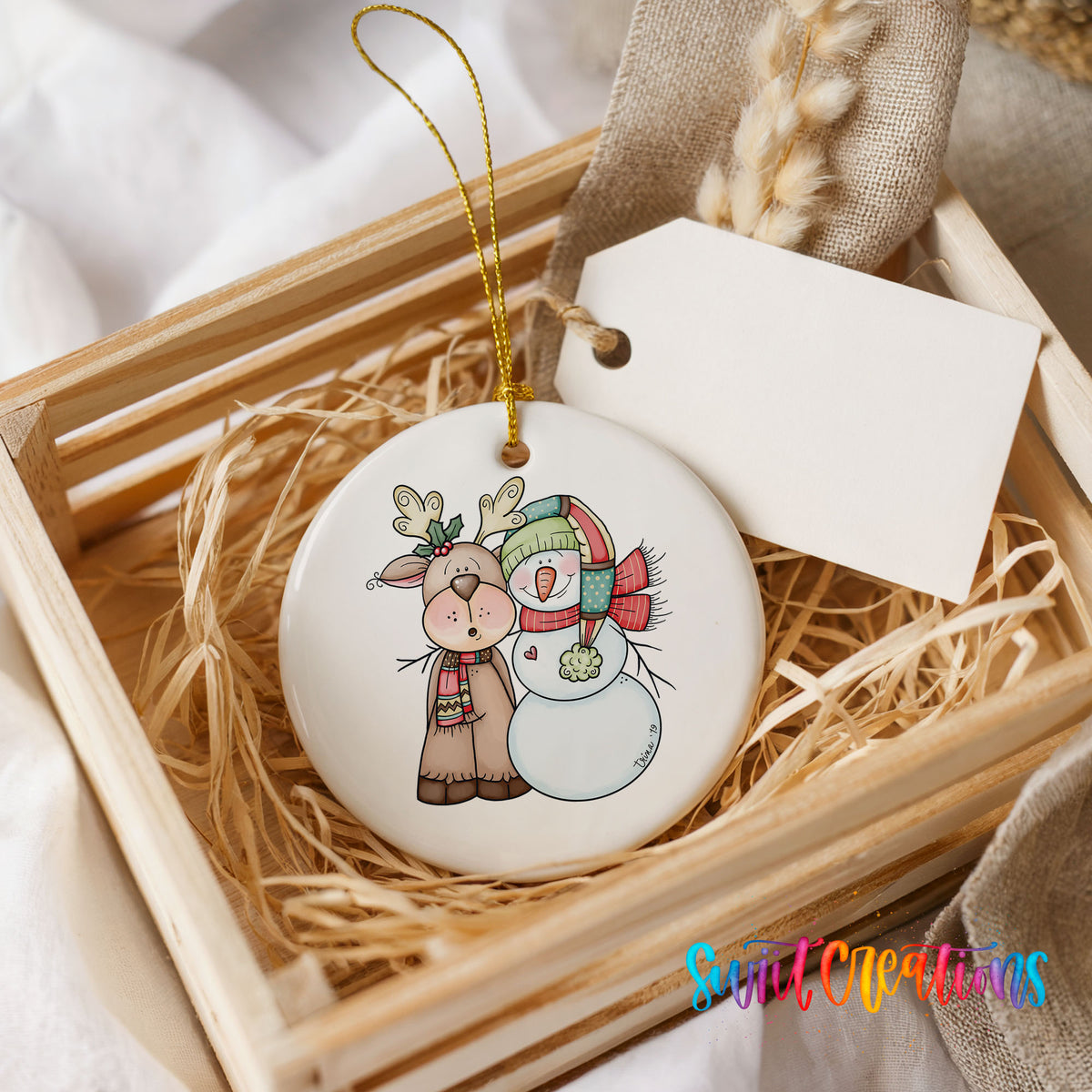Reindeer and snowman ornament displayed in a rustic wooden gift crate