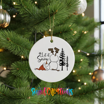 Let It Snow snowman winter forest ceramic Christmas ornament hanging on a green Christmas tree