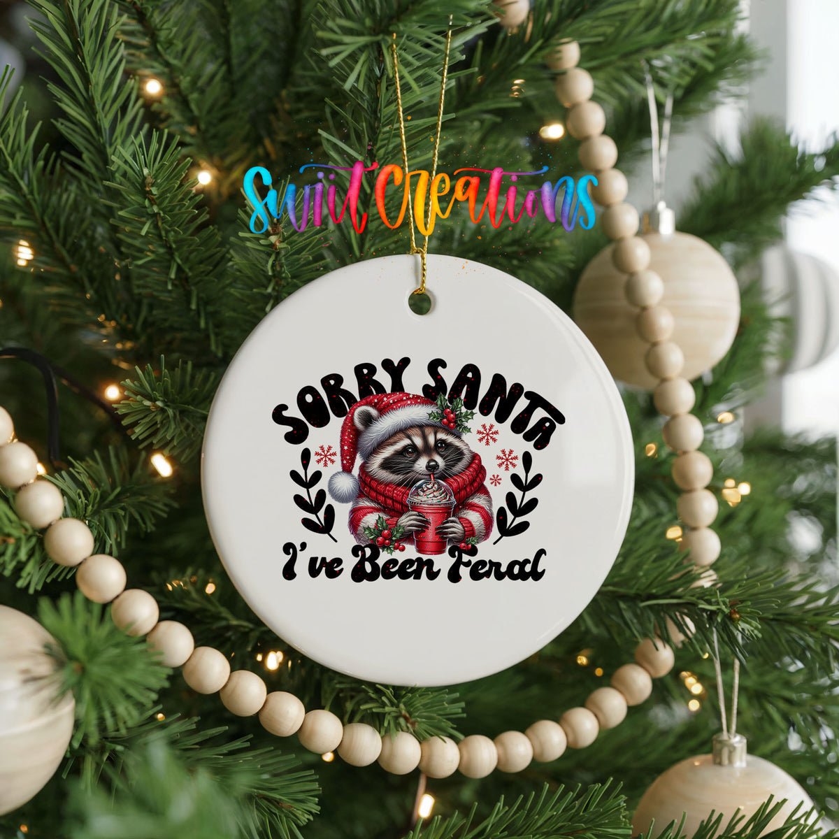 Sorry Santa I've Been Feral funny raccoon ceramic Christmas ornament hanging on a decorated Christmas tree