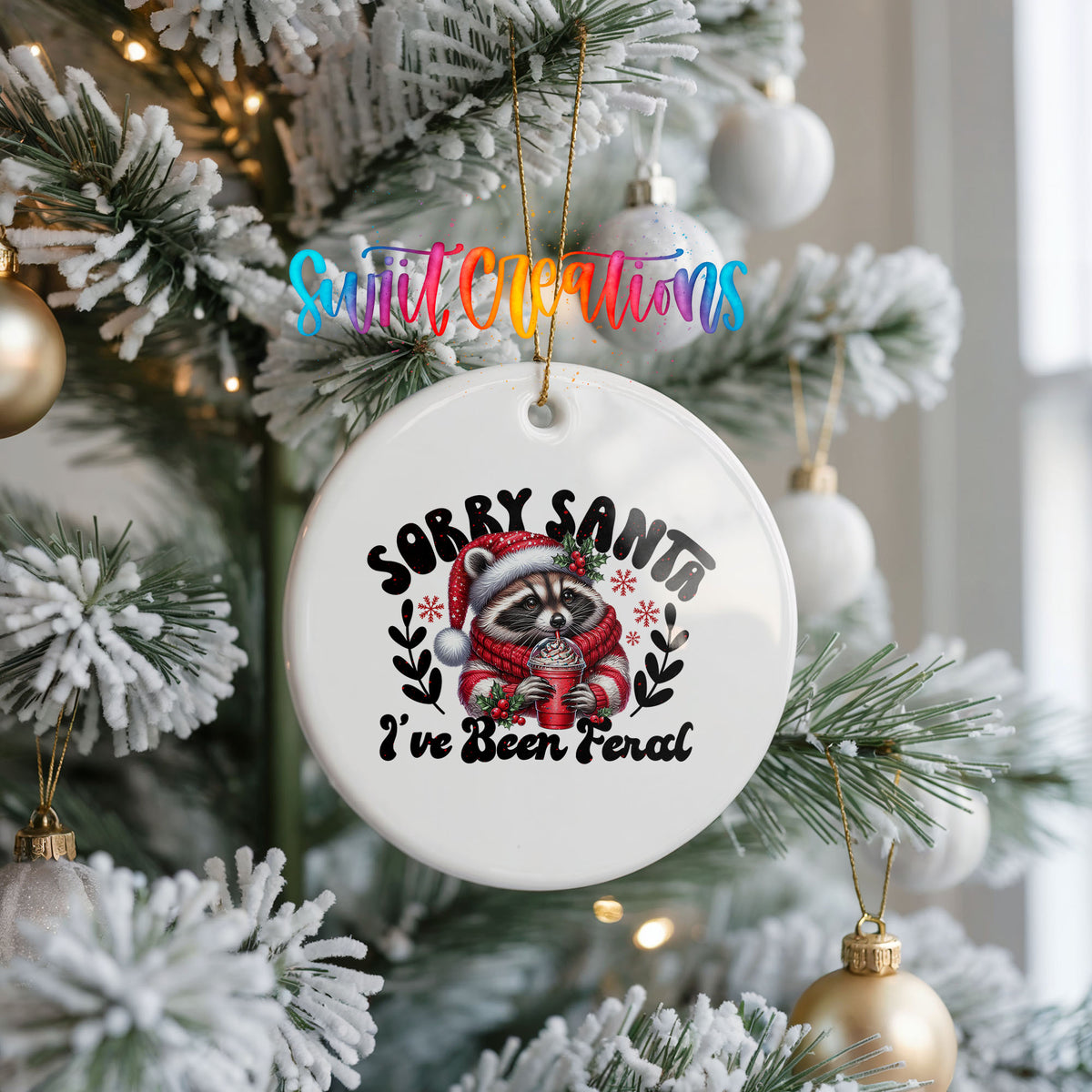 Sorry Santa I've Been Feral funny raccoon ceramic Christmas ornament hanging on a frosted Christmas tree