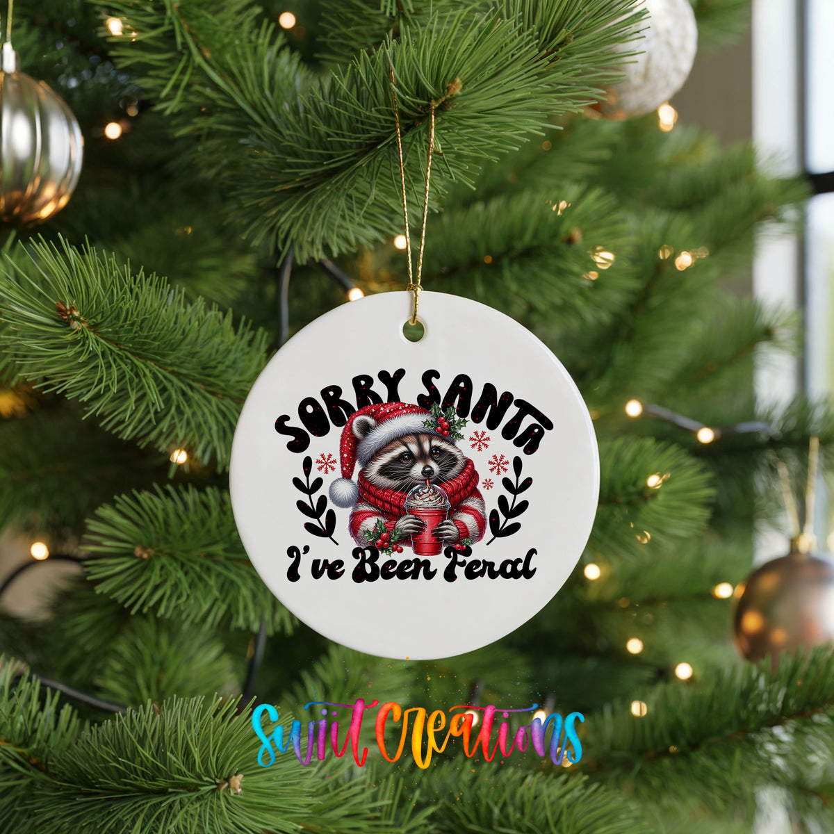 Sorry Santa I've Been Feral funny raccoon ceramic Christmas ornament hanging on a green Christmas tree