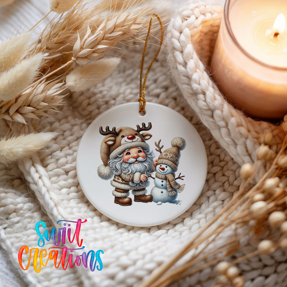 Whimsical Santa reindeer and snowman ceramic Christmas ornament styled beside a candle and cozy knit blanket