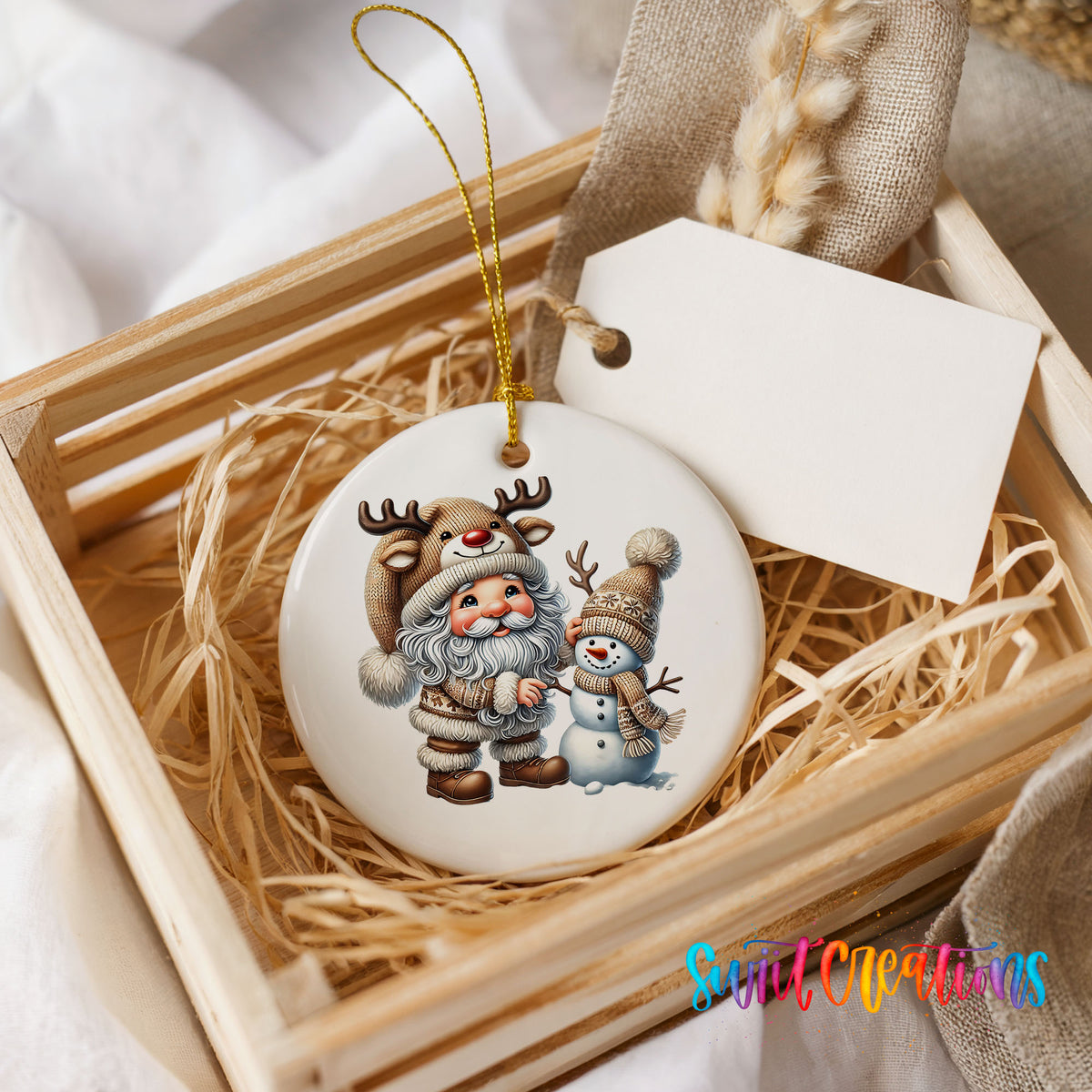 Whimsical Santa reindeer and snowman ceramic Christmas ornament displayed in a rustic wooden gift crate