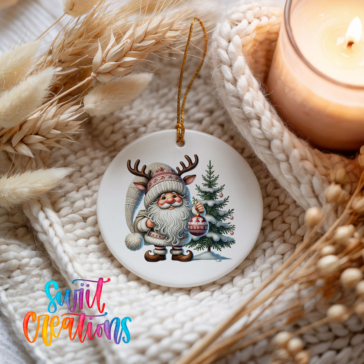 Cozy Santa with reindeer hat and Christmas tree ceramic ornament styled beside a candle and cozy knit blanket