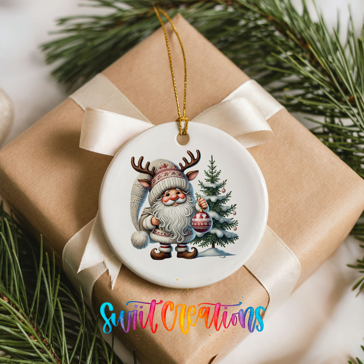 Cozy Santa with reindeer hat and Christmas tree ceramic ornament arranged on a wrapped Christmas gift