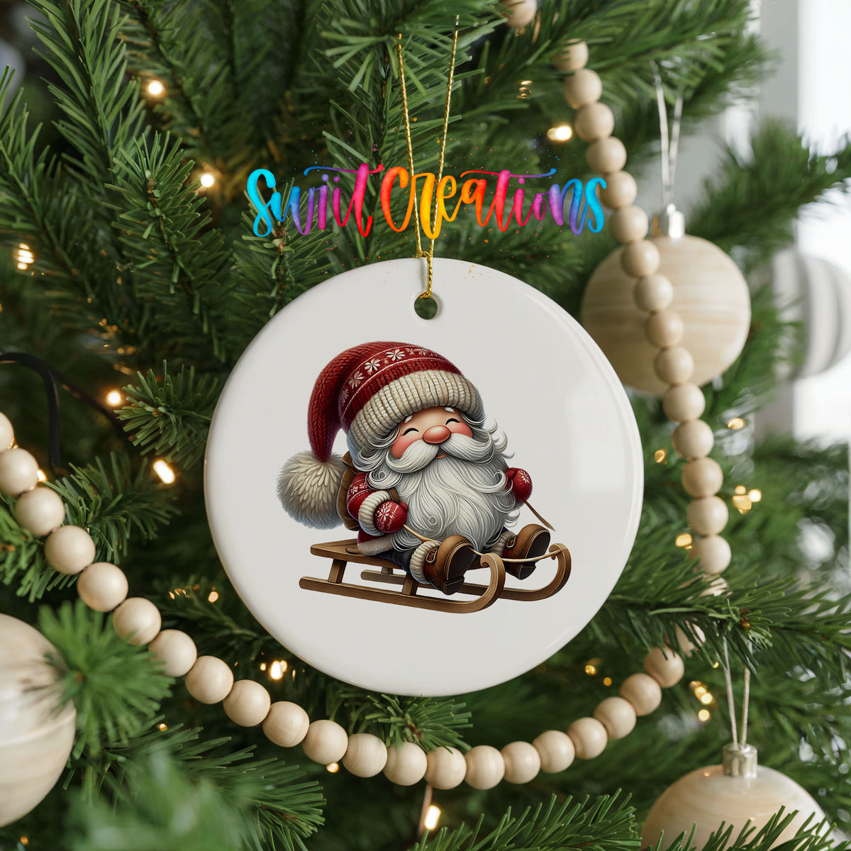 Sleeping Santa on a sled ceramic Christmas ornament hanging on a decorated Christmas tree