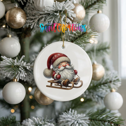 Sleeping Santa on a sled ceramic Christmas ornament hanging on a frosted holiday tree