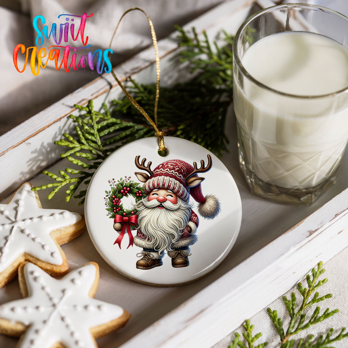 Cozy Santa holding a Christmas wreath ceramic ornament styled with cookies and milk