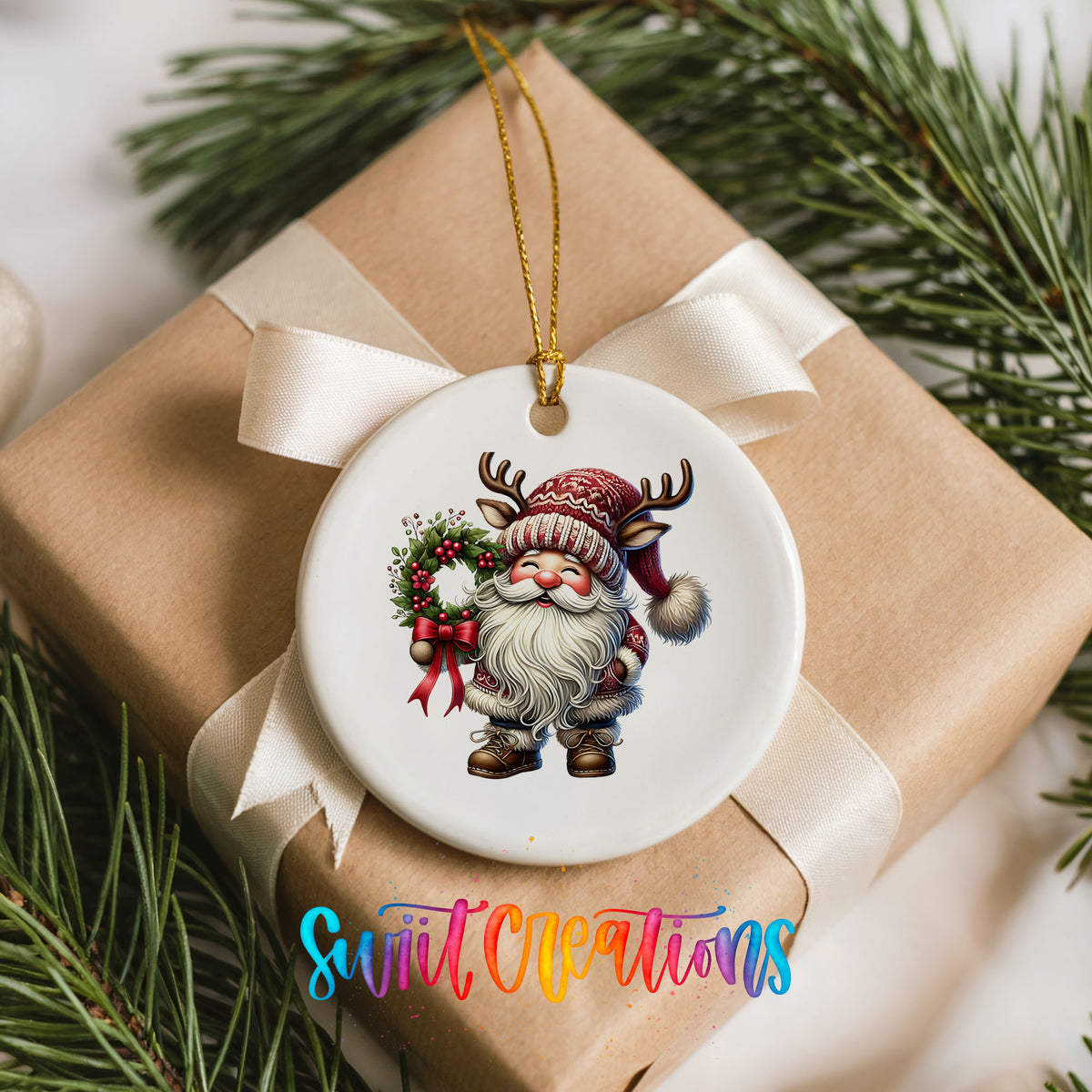 Cozy Santa holding a Christmas wreath ceramic ornament arranged on a wrapped Christmas gift