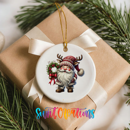 Cozy Santa holding a Christmas wreath ceramic ornament arranged on a wrapped Christmas gift