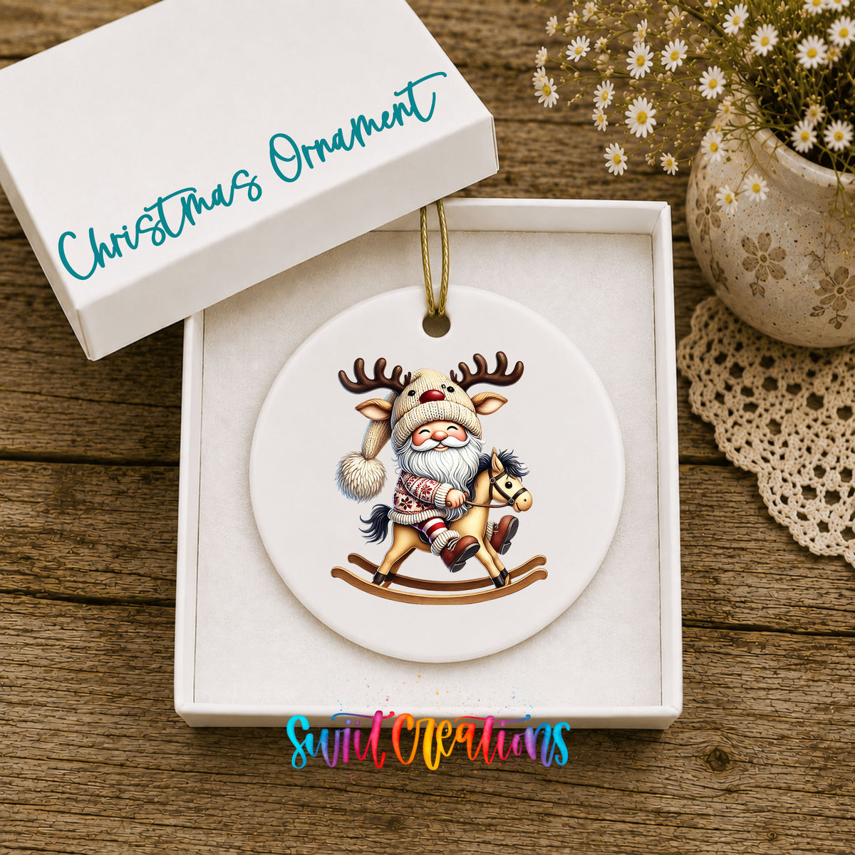 Whimsical Santa riding a rocking horse ceramic Christmas ornament displayed in the included gift box