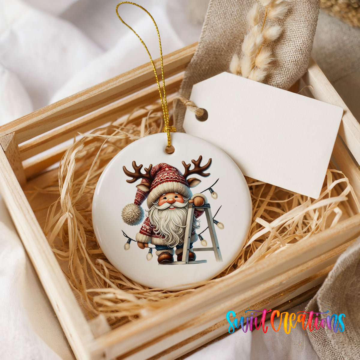 Santa decorating Christmas lights ceramic ornament displayed in a rustic wooden gift crate