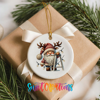 Santa decorating Christmas lights ceramic ornament arranged on a wrapped Christmas gift