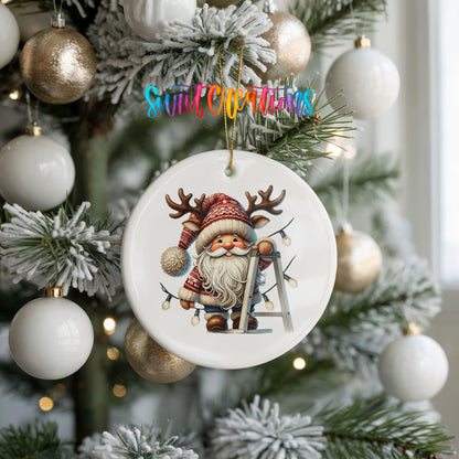 Santa decorating Christmas lights ceramic ornament hanging on a frosted holiday tree