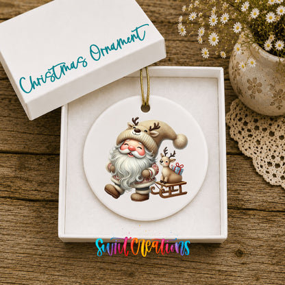 Santa pulling a reindeer sled ceramic Christmas ornament displayed in the included gift box