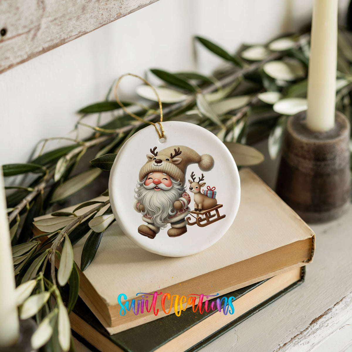 Santa pulling a reindeer sled ceramic Christmas ornament styled on books with holiday greenery